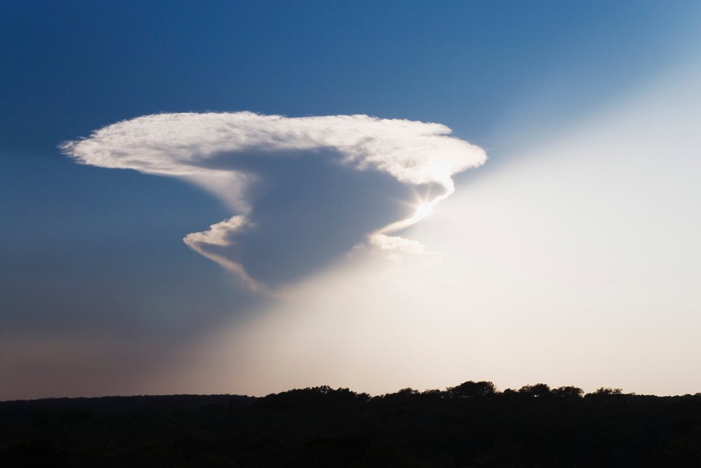Sunlight appearing from behind cloud over Texas landscape