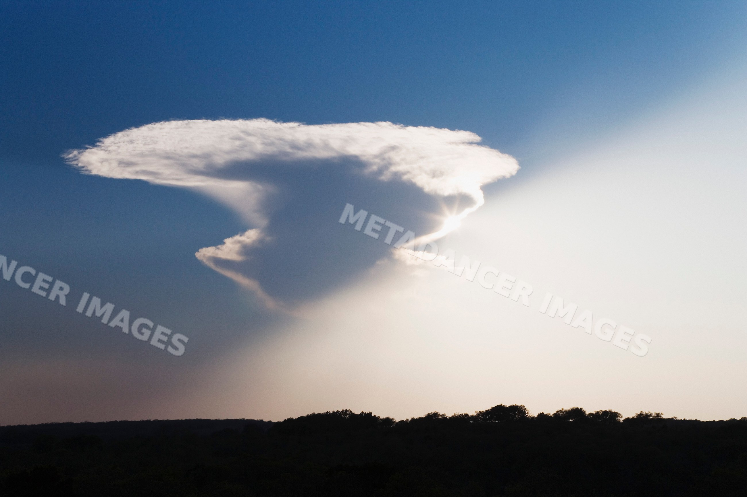Sunlight appearing from behind cloud over Texas landscape