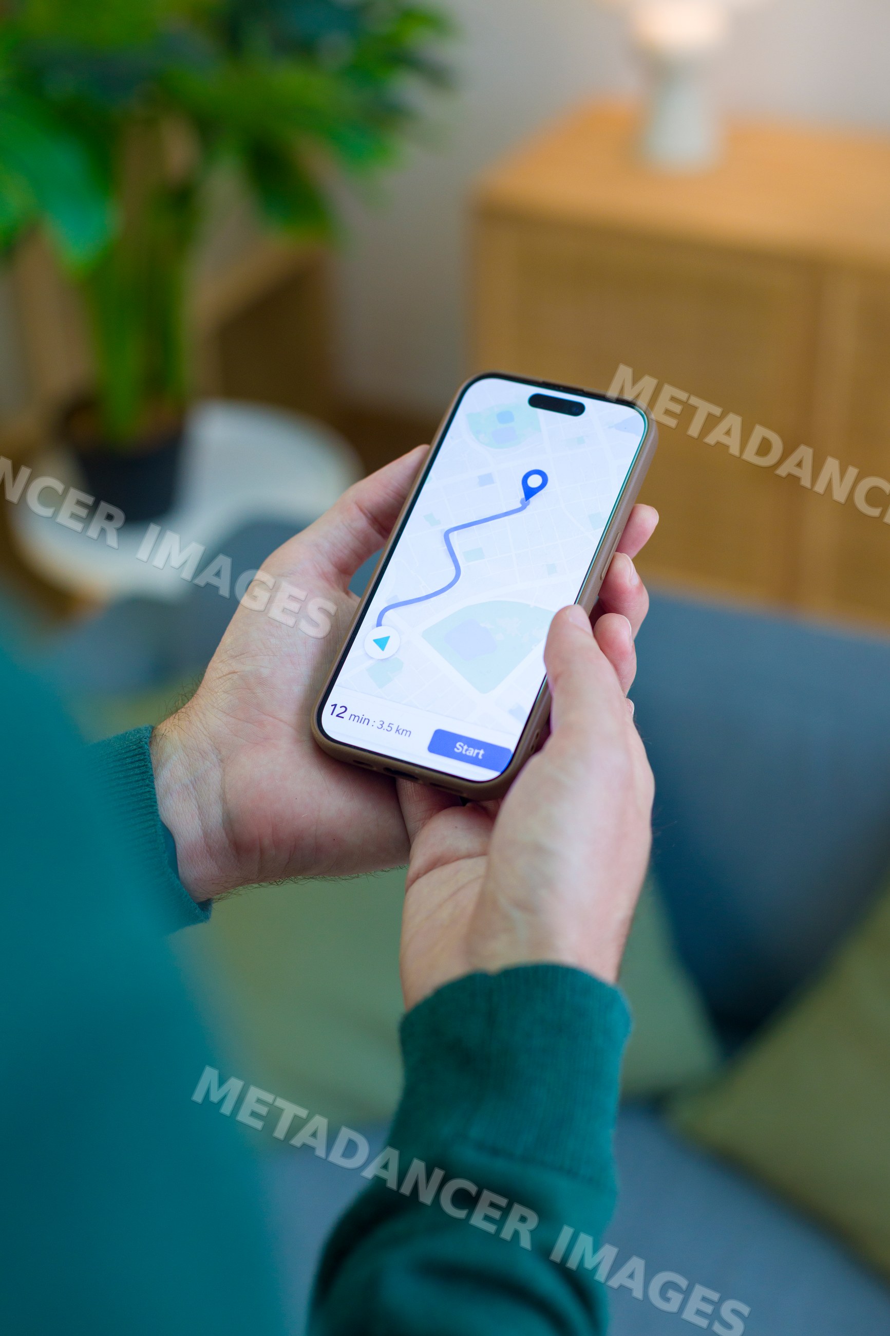 White person holding smartphone showing navigation route map indoors