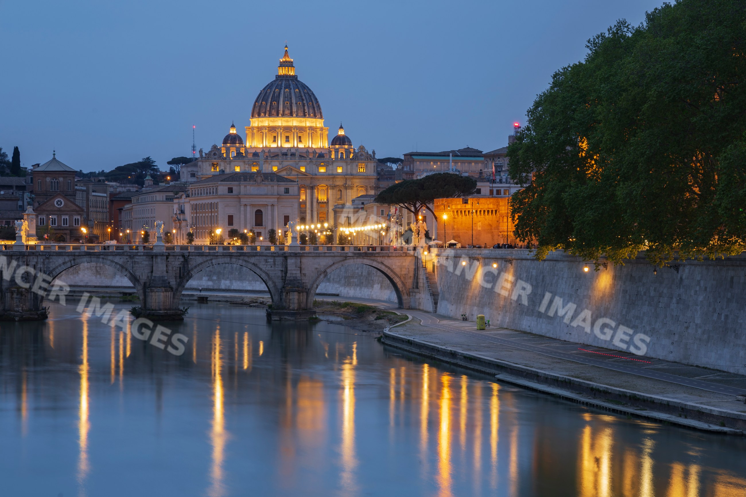 Basilica of St Peter's at Dusk with river and arched bridge in rome
