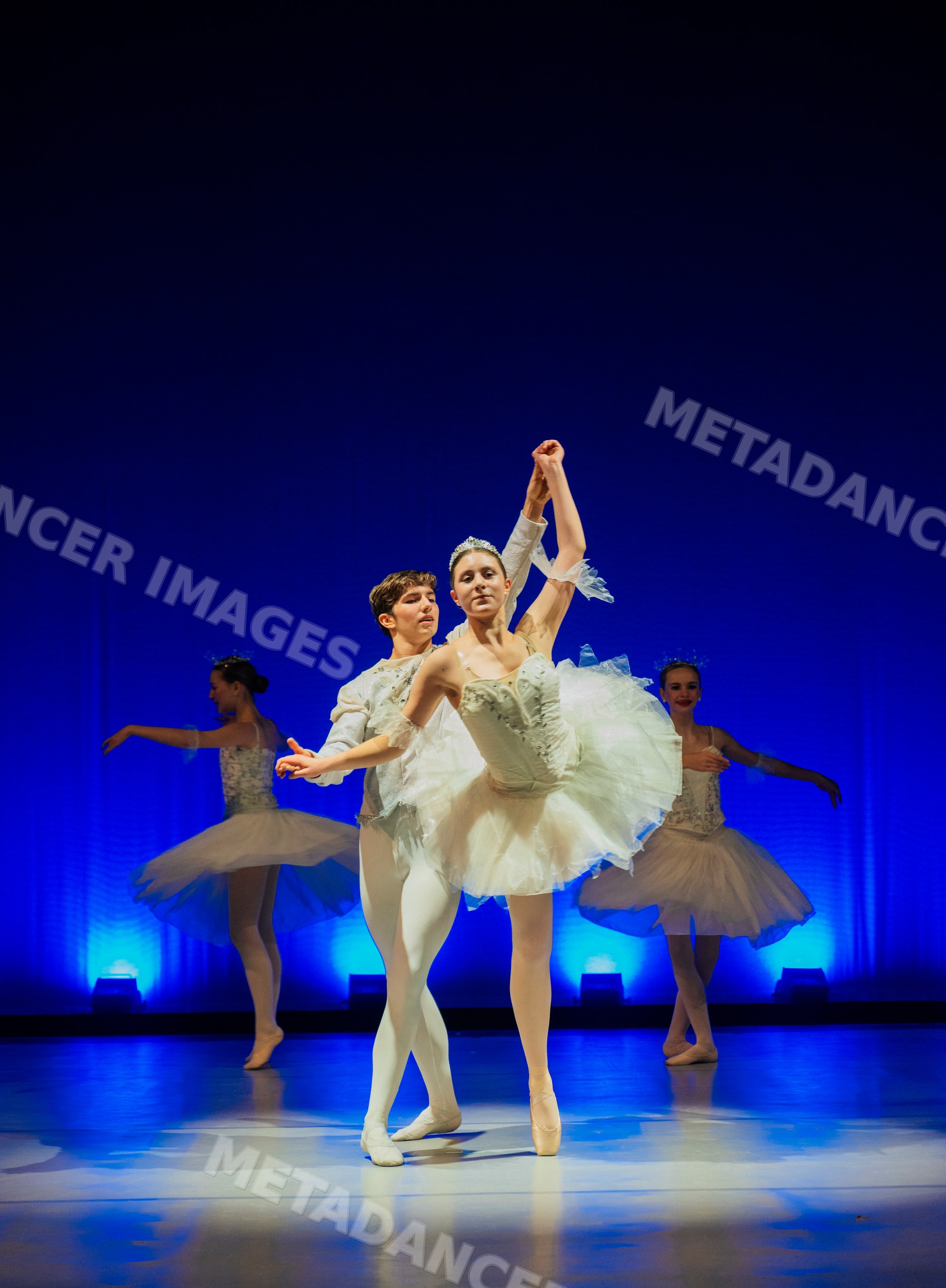 Male and female ballet dancers performing a pas de deux on stage
