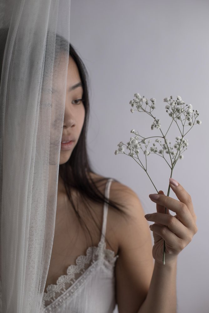 Southeast Asian woman holding delicate baby's breath flowers