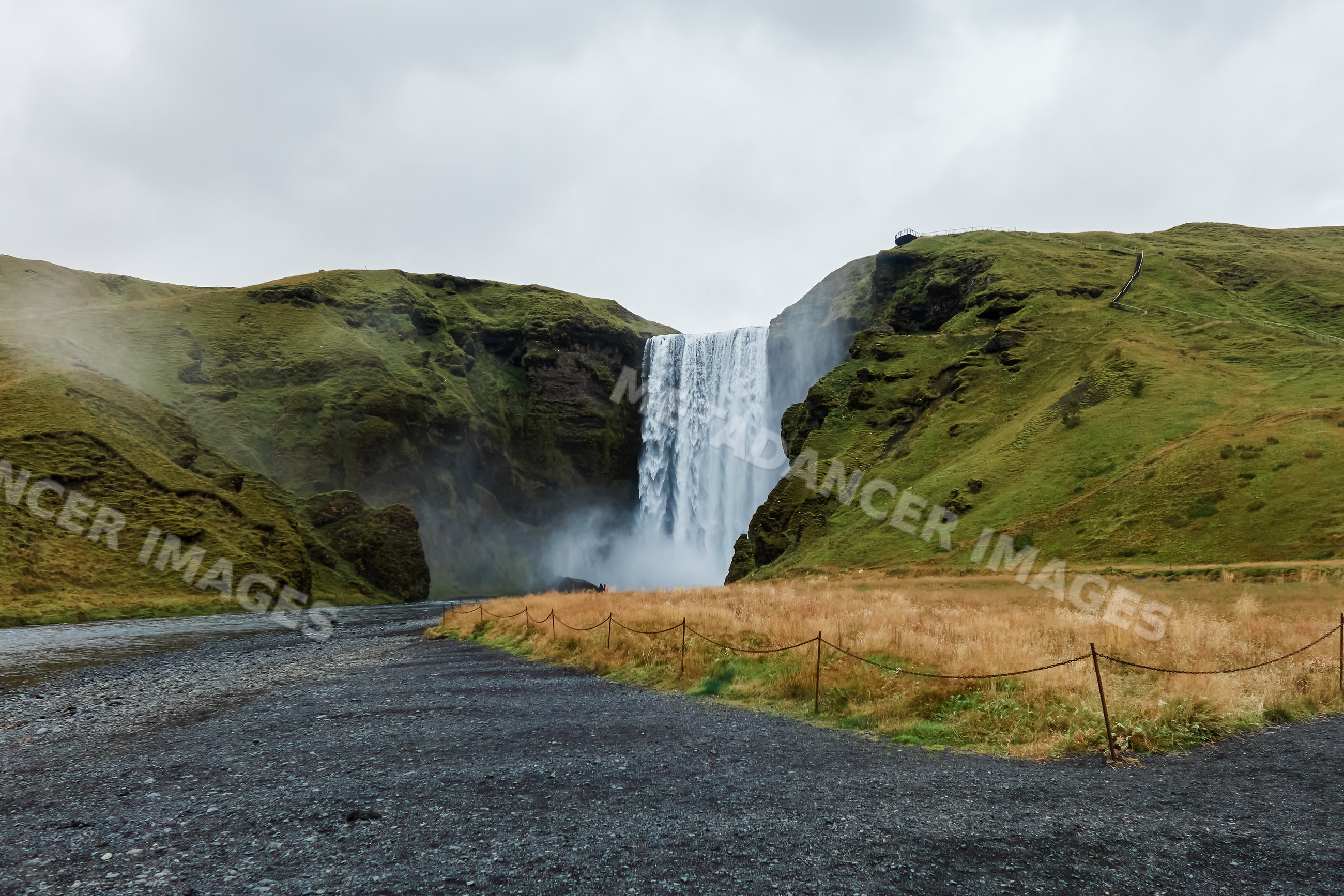 Waterfall cascading over green cliffs