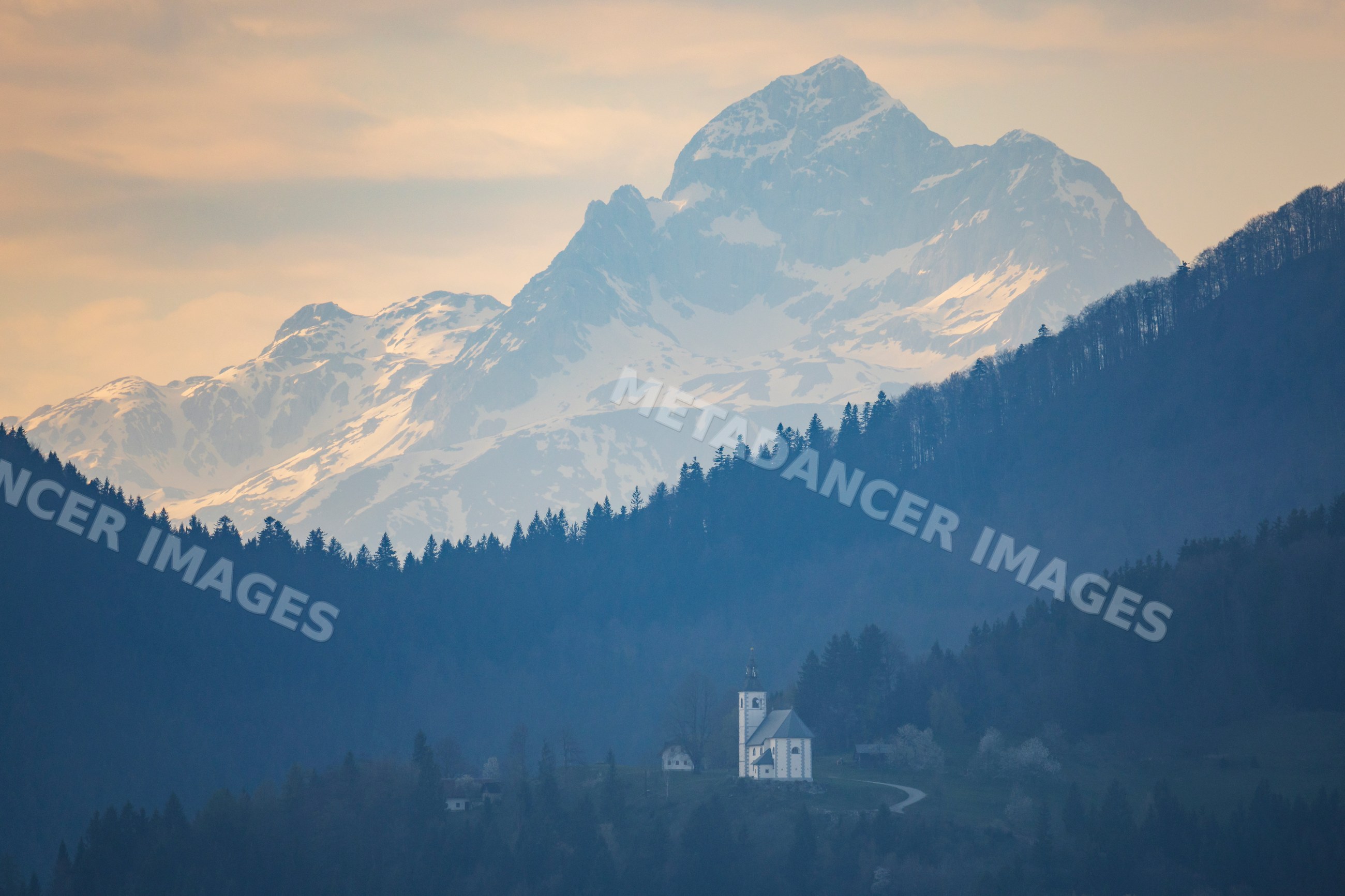 Small church on hill before mount triglav in skofje loka Slovenia