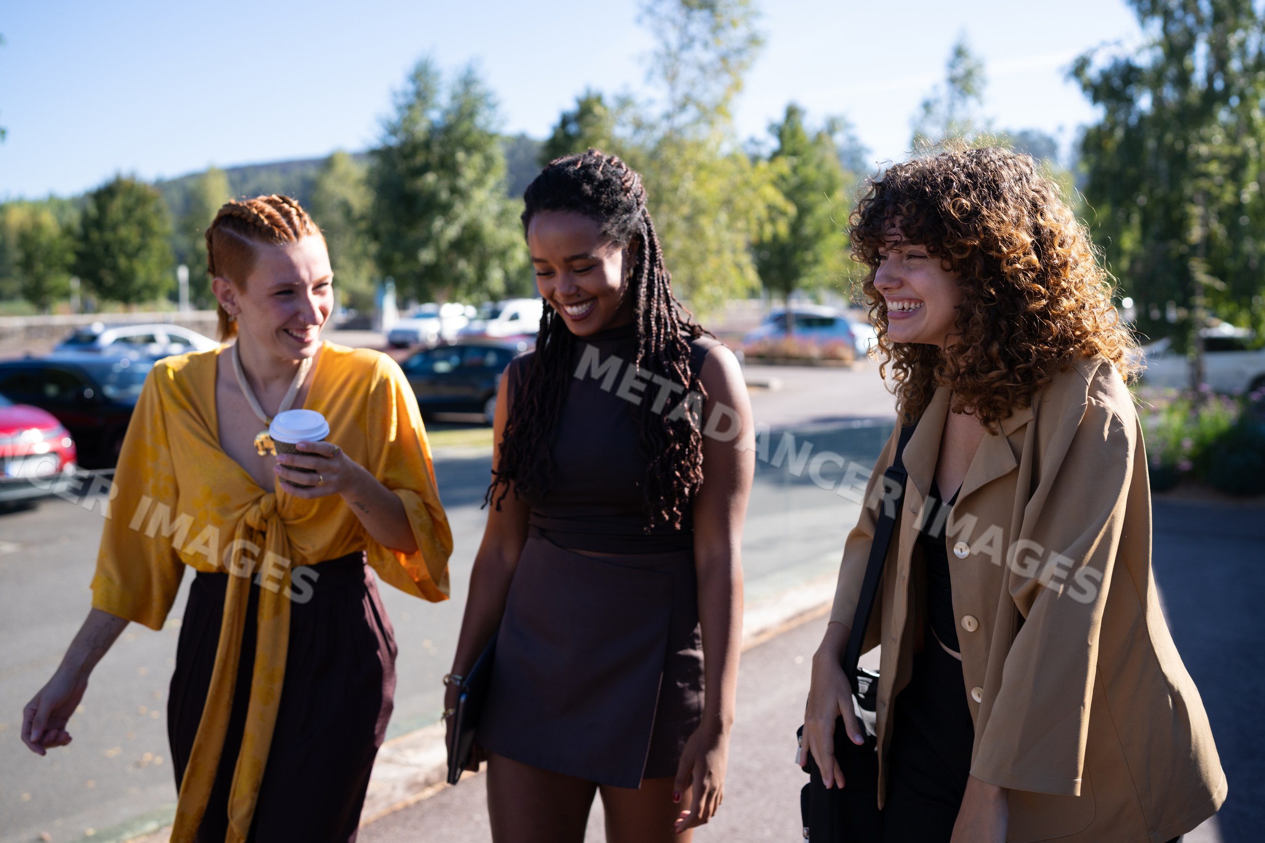 Three diverse African American and white women walking and laughing