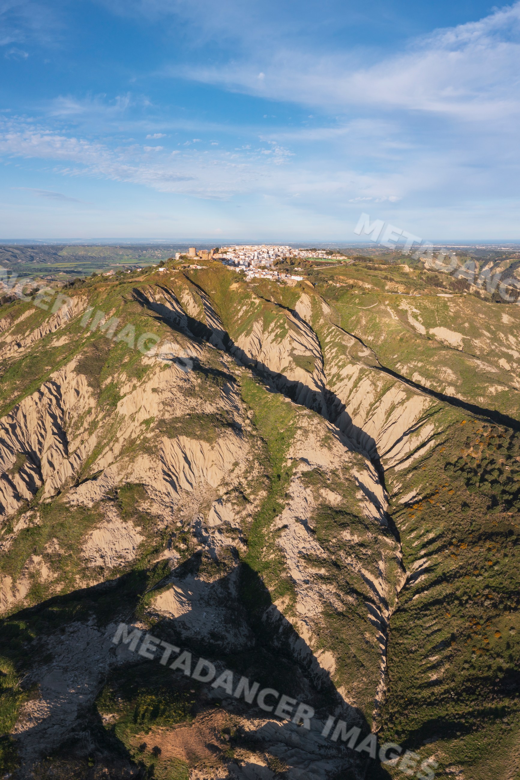 Hill town of Pisticci with rugged calanche hills in basilicata, Italy