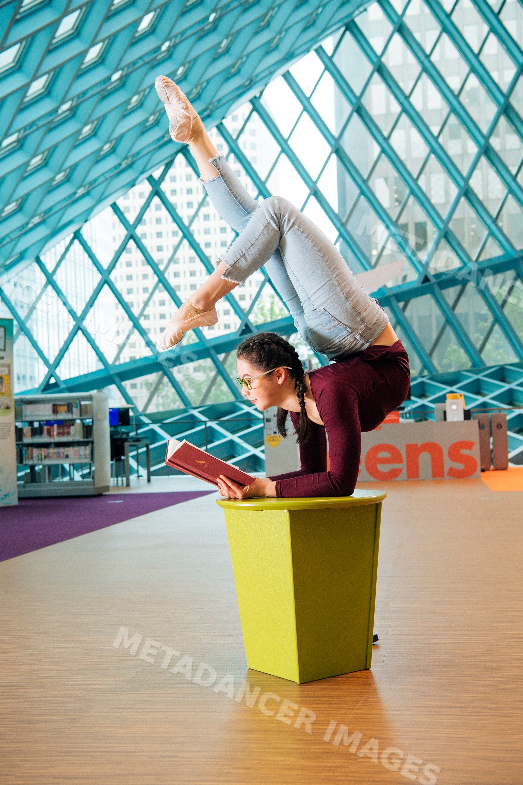 A woman balances in a contortionist pose while reading in a Seattle
