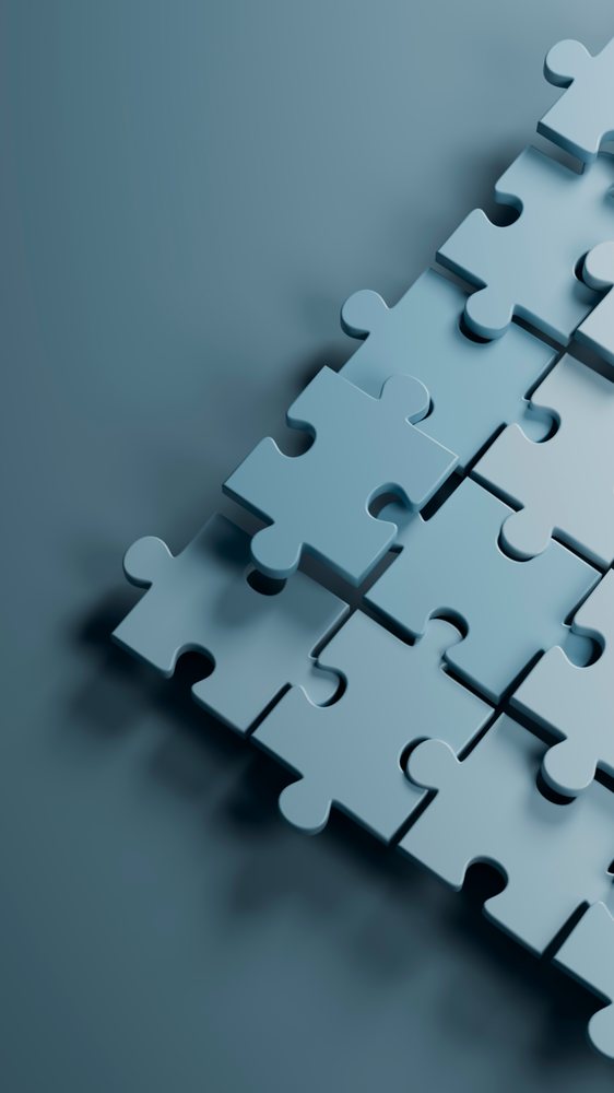 Blue three-dimensional puzzle pieces with one piece lifted