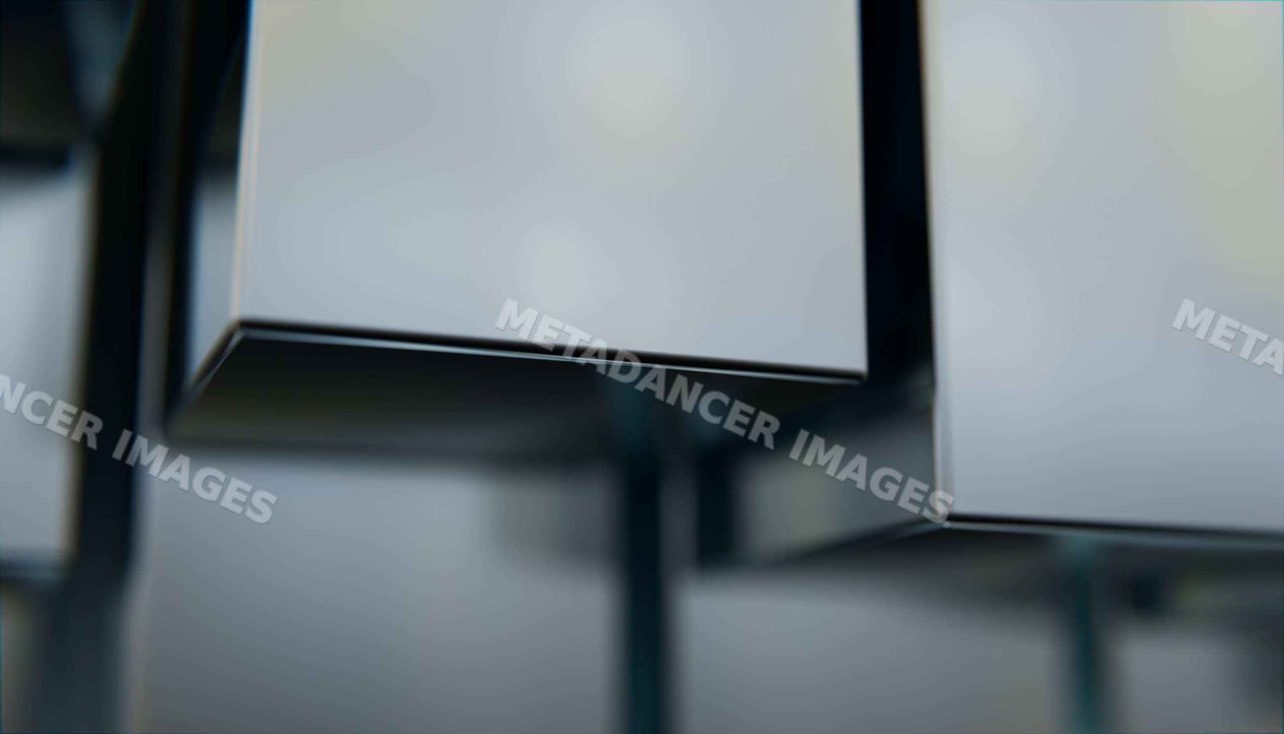 Close-up of stacked metallic rectangular boxes with smooth surfaces
