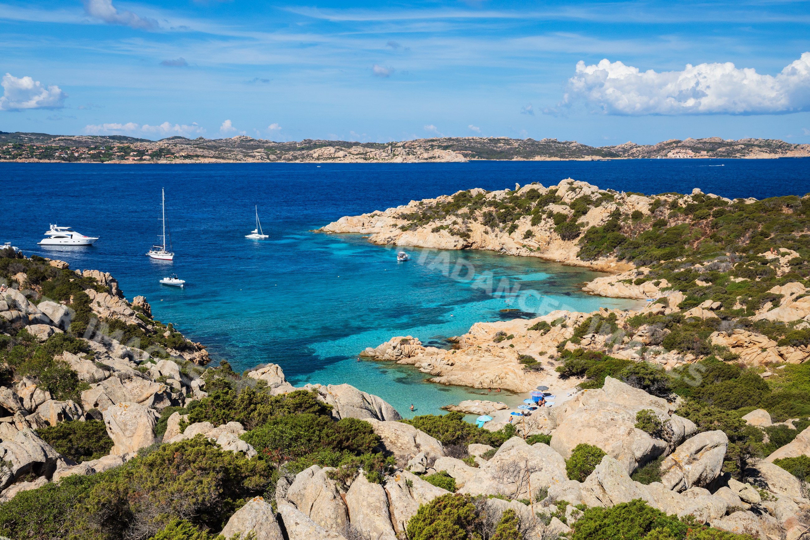 Cala Napoletana bay with boats on caprera island, corsica, italy
