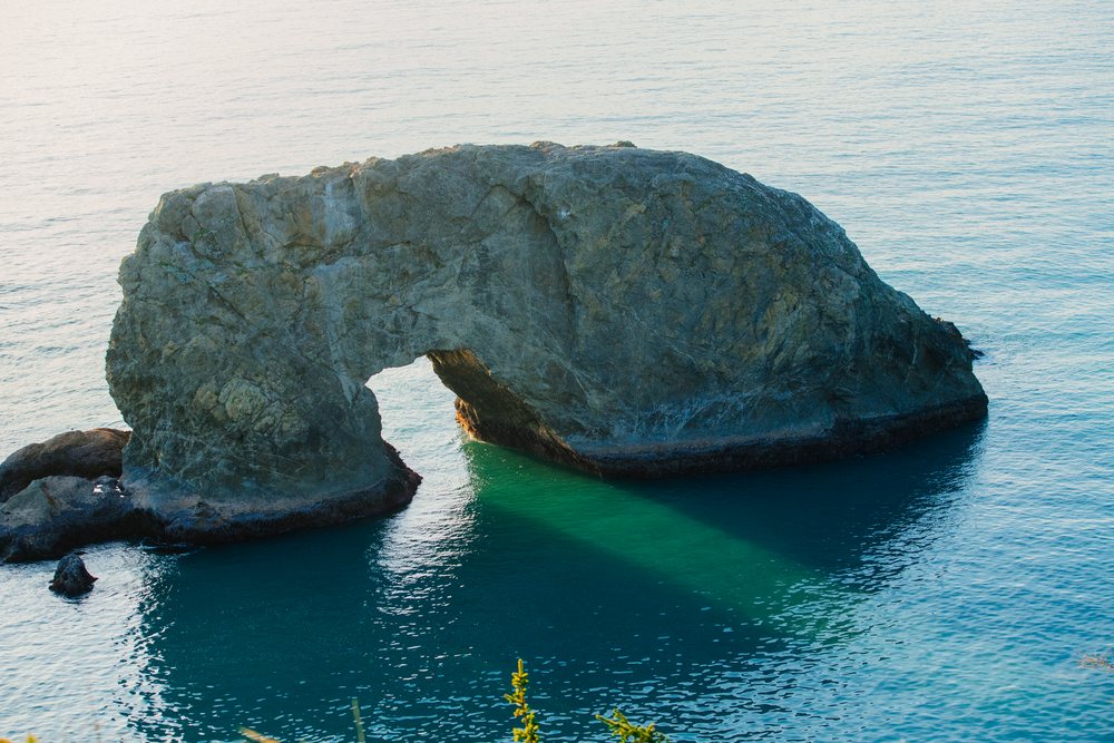 Natural rock arch in ocean Oregon