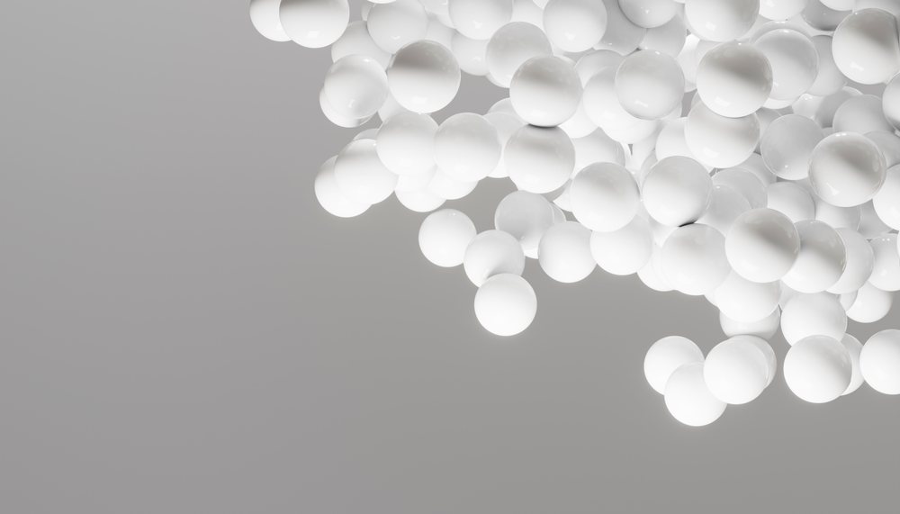 Cluster of smooth white spheres floating against a light gray