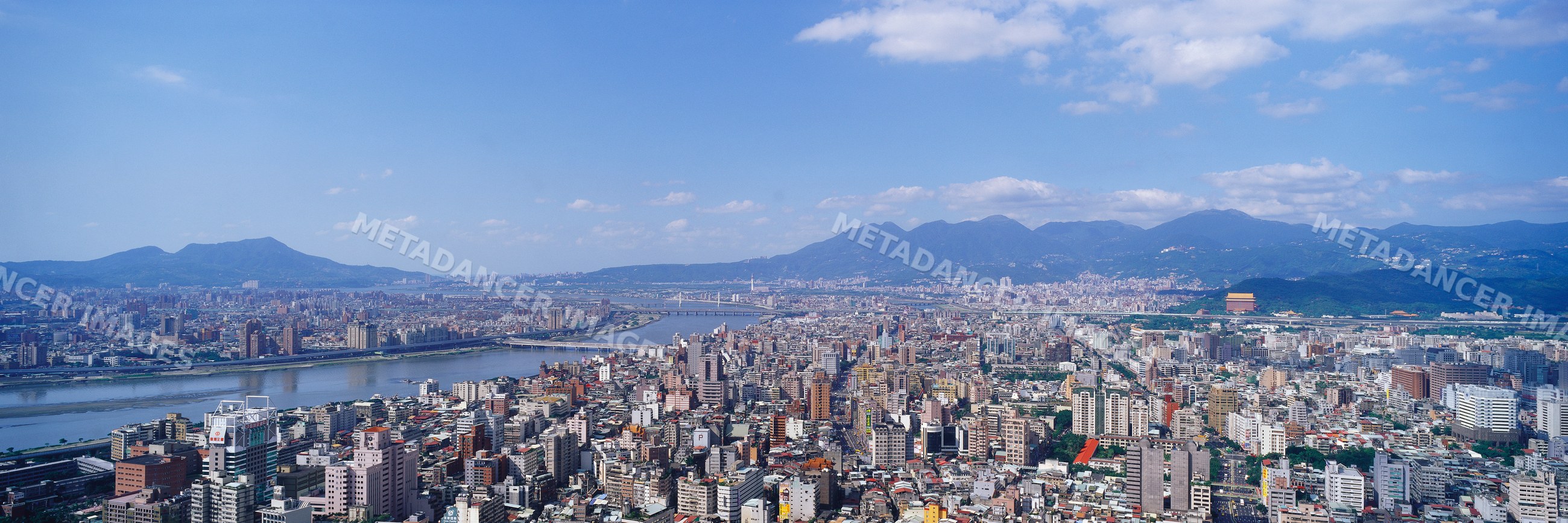 Urban cityscape with river and bridges under blue sky
