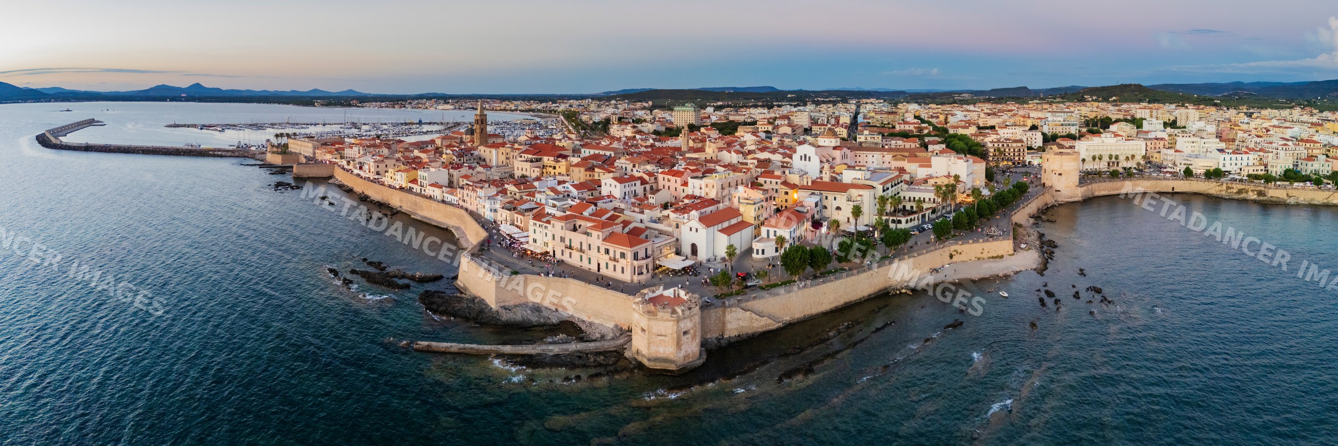 Skyline of Alghero Old City at dusk on sardinia coast