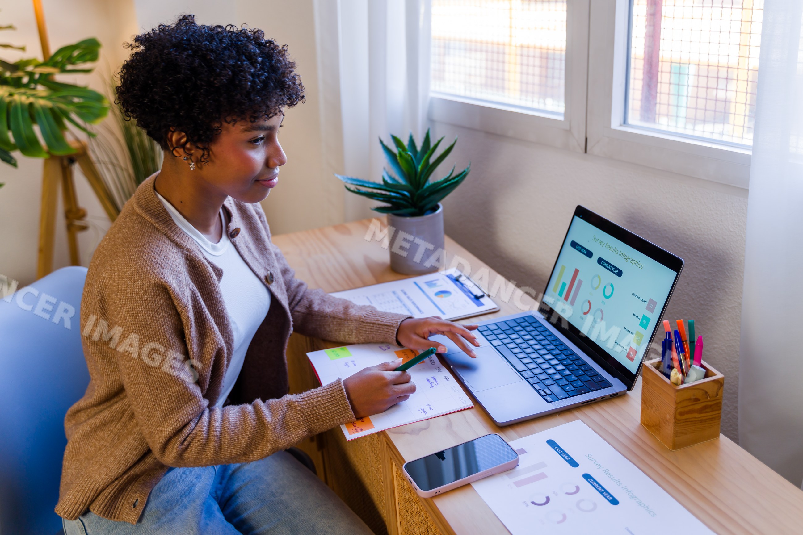 African American woman analyzing survey results on laptop