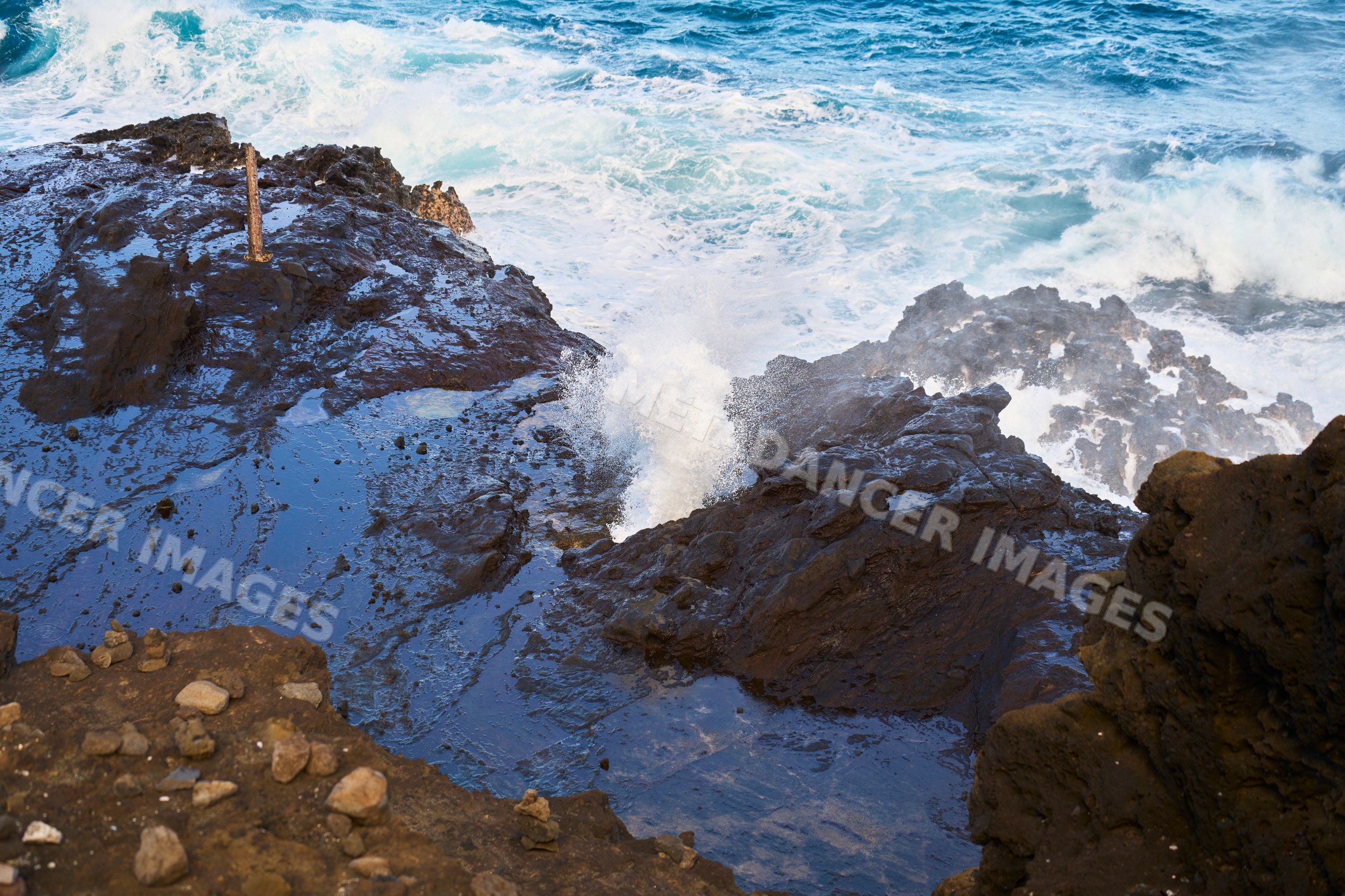 Rocky coastline with ocean waves crashing in Oahu, Hawaii