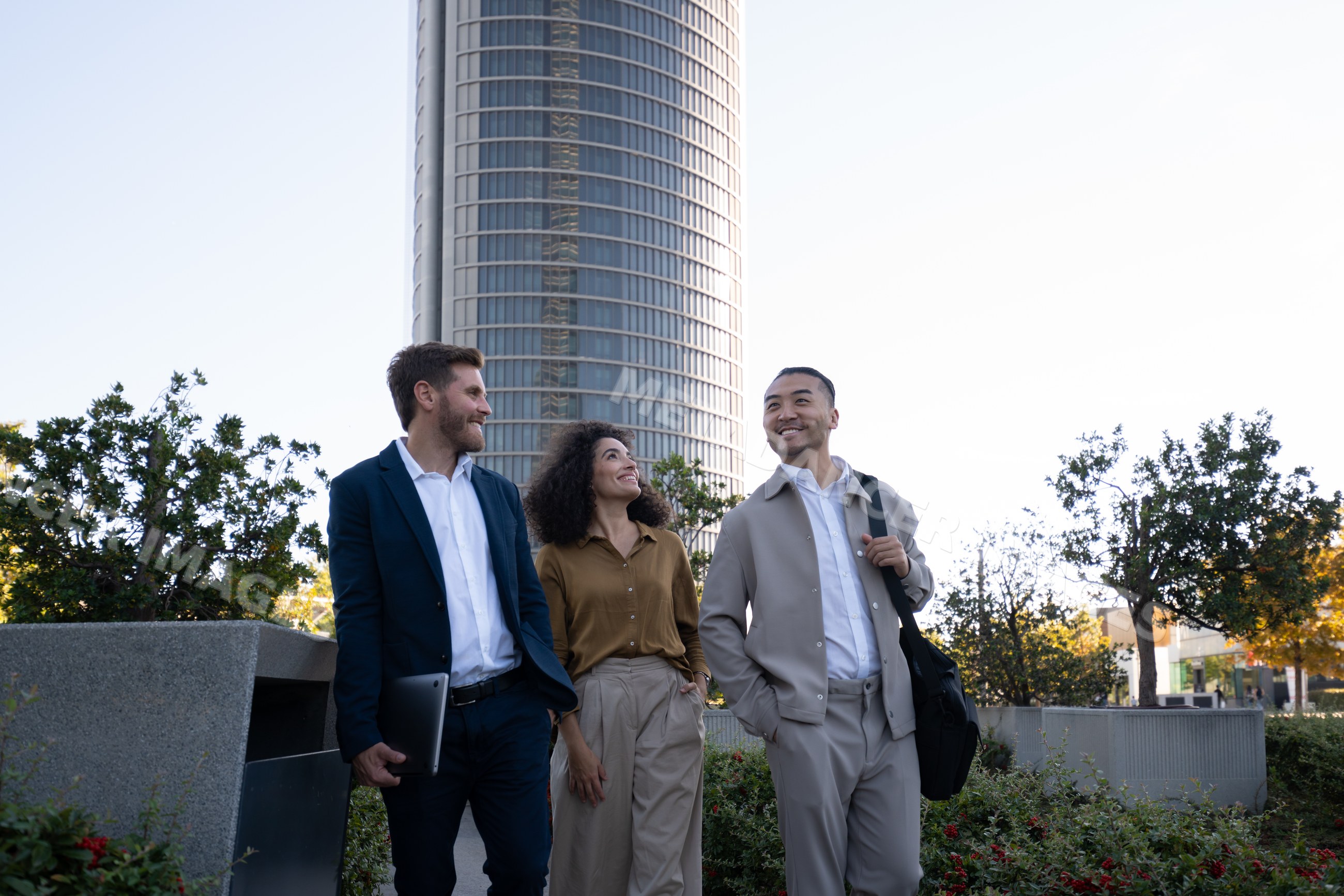 Diverse business group walking and talking in urban park in Madrid