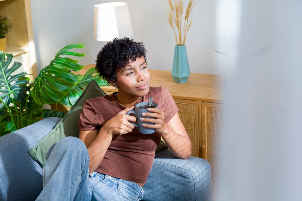Young African American woman relaxing with coffee