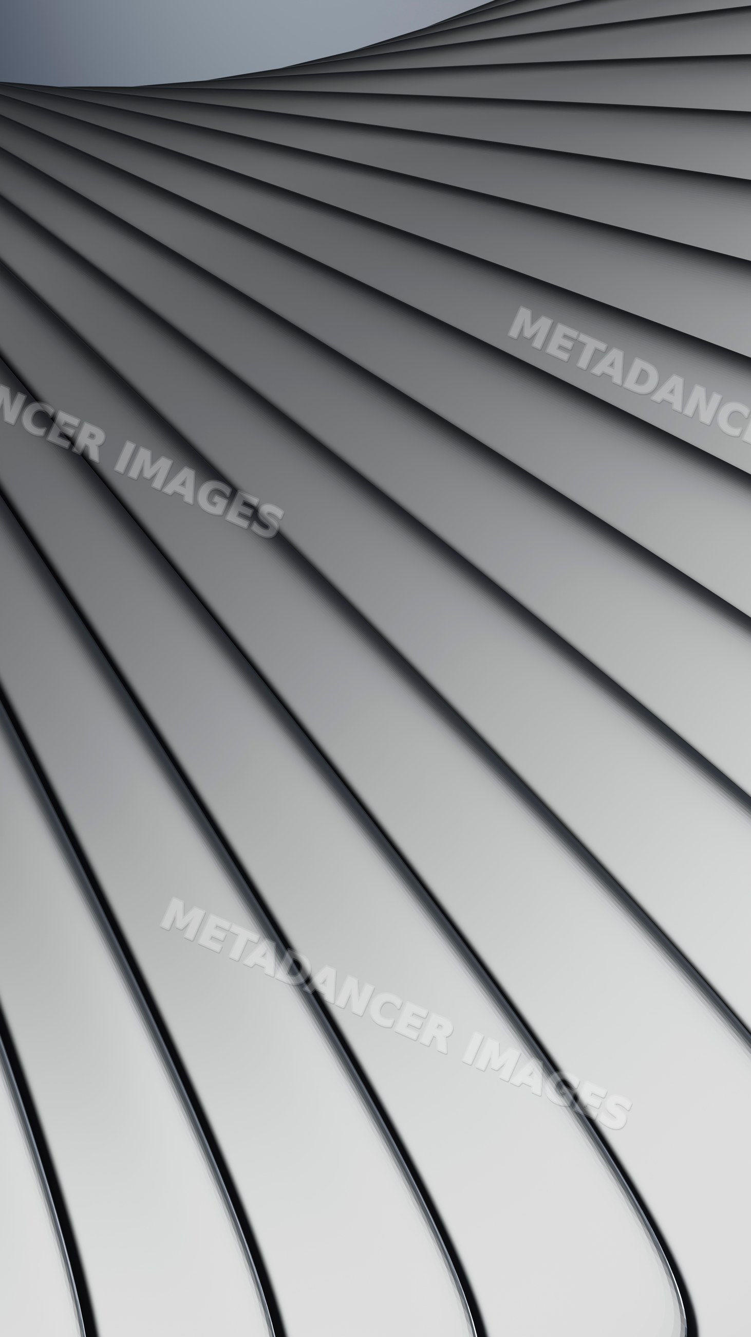 Stacked stainless steel spoons with reflective surfaces and smooth