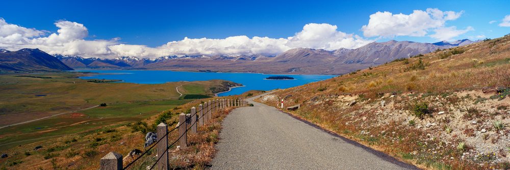 Road overlooking lake and mountains with scenic landscape view