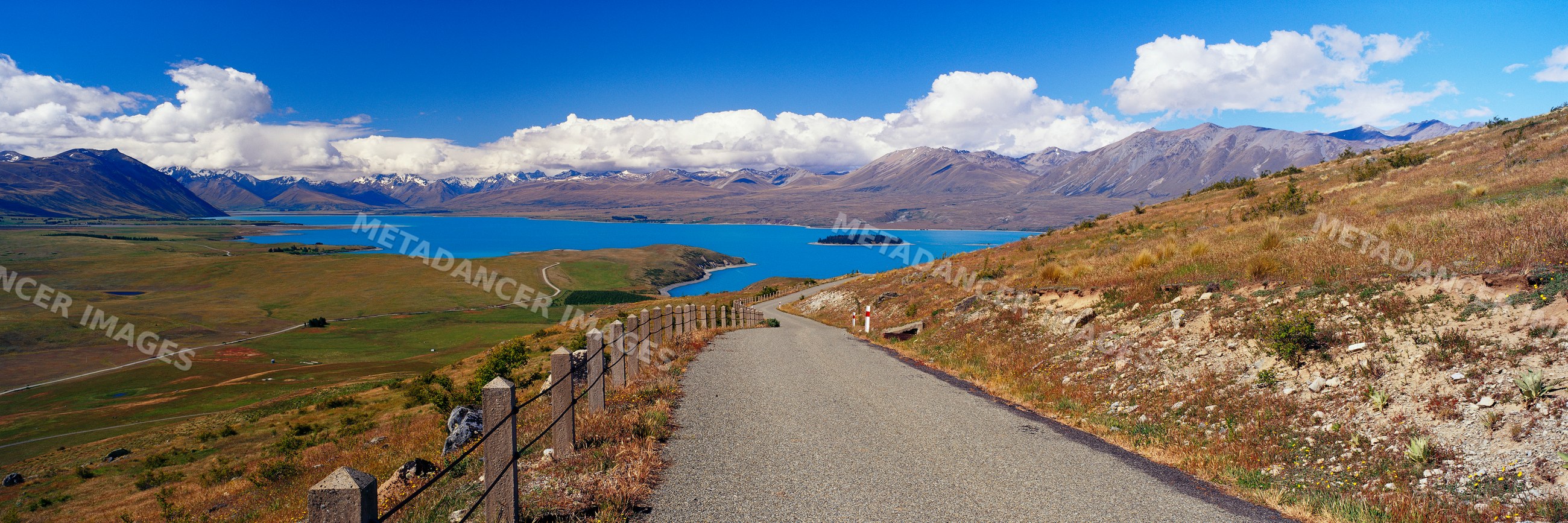 Road overlooking lake and mountains with scenic landscape view
