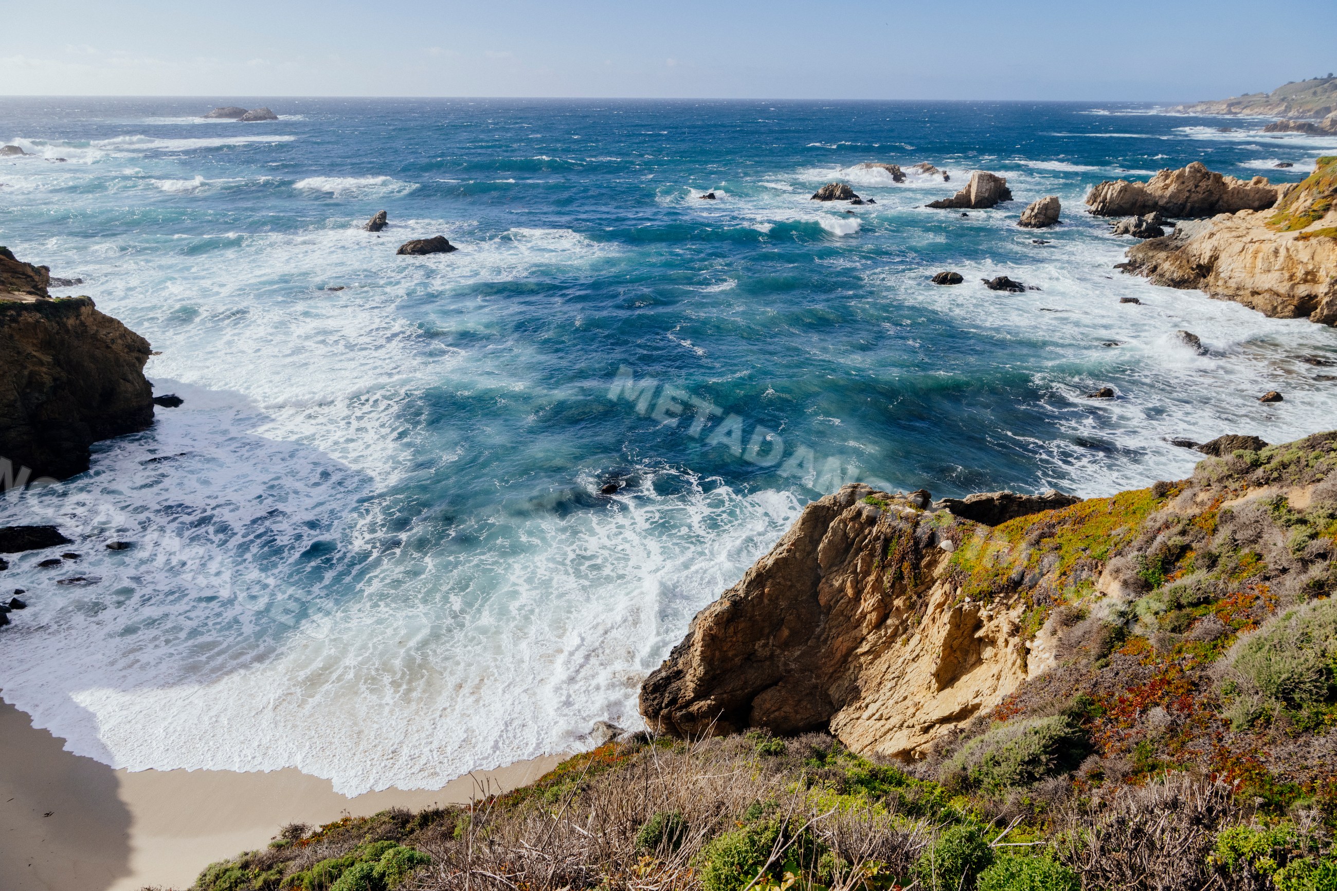 Ocean waves crashing on rocky California coastline