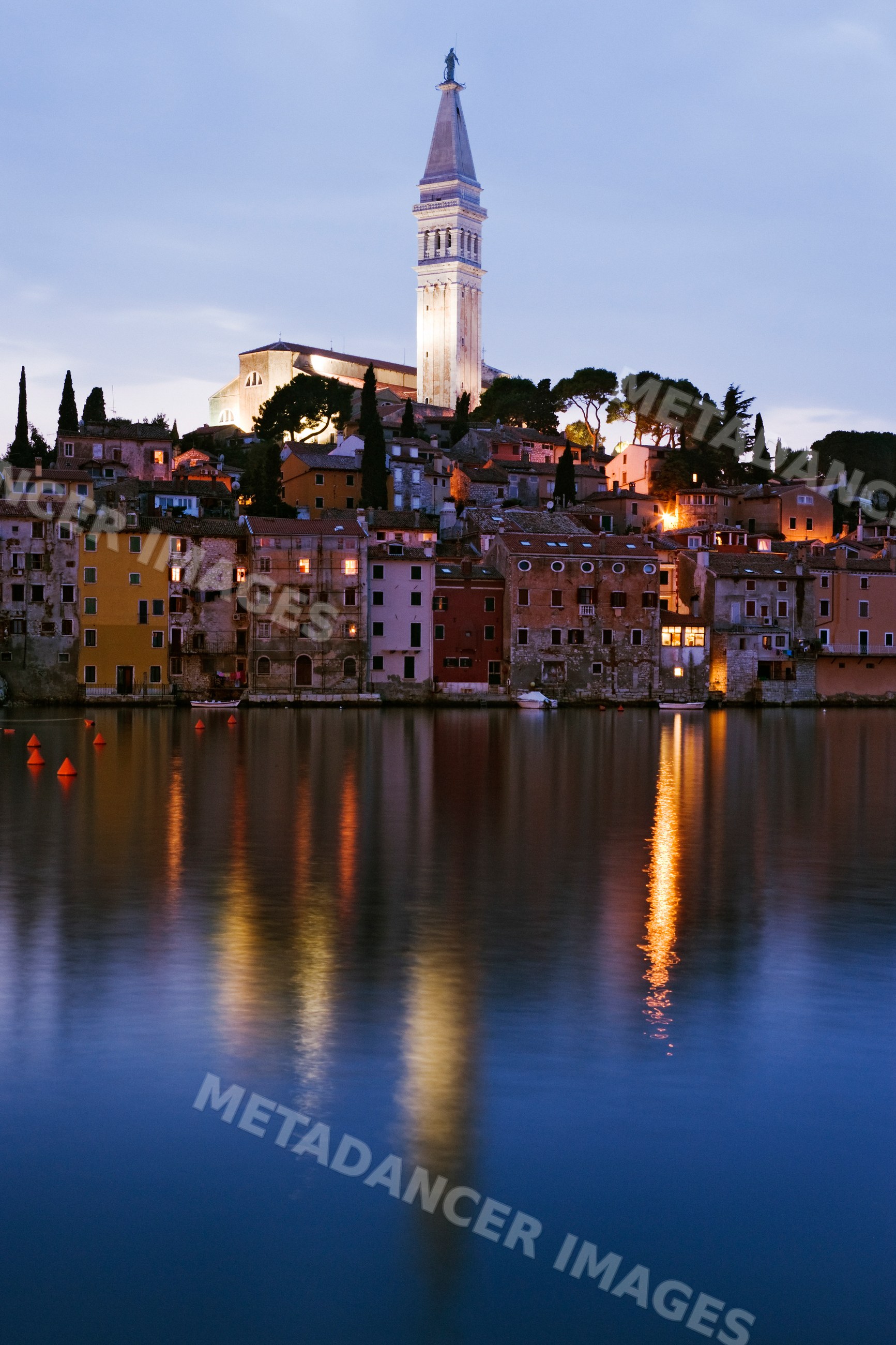 Rovinj waterfront with church tower and reflections