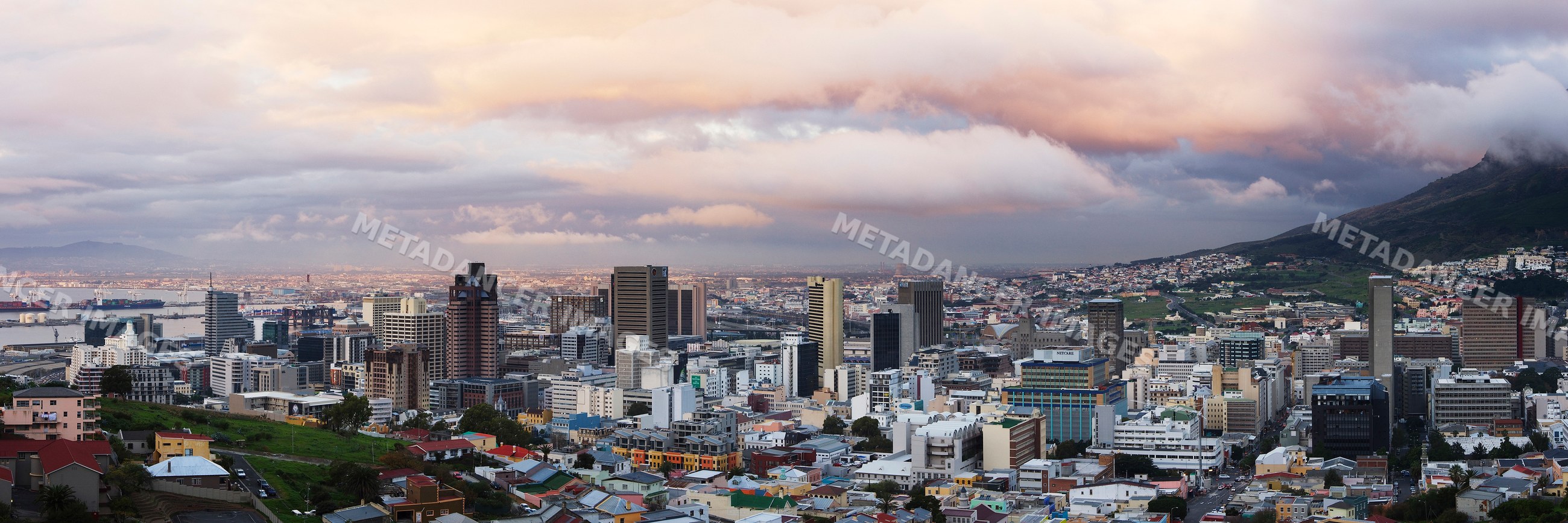 Cape town city skyline with harbor and mountains at sunset