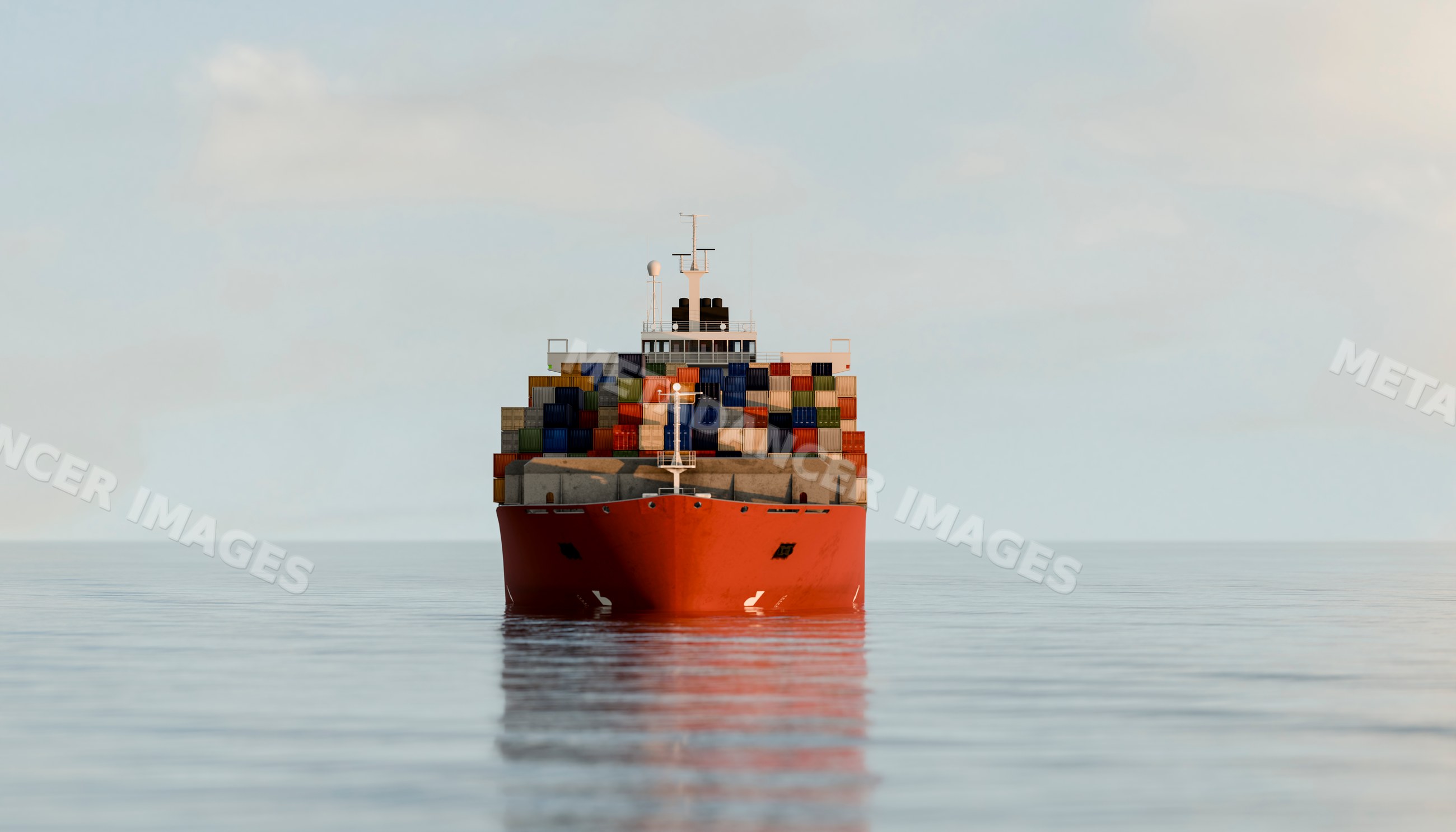 A red container ship loaded with cargo containers sails on calm ocean