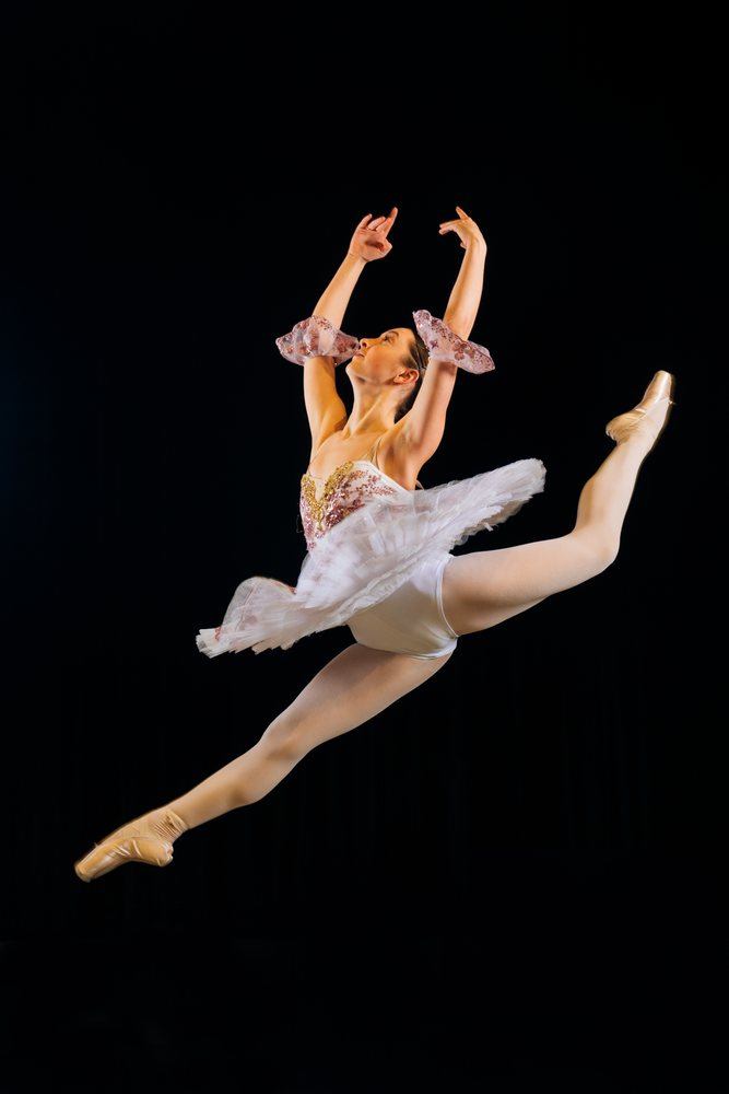 Female ballet dancer performs a graceful leap