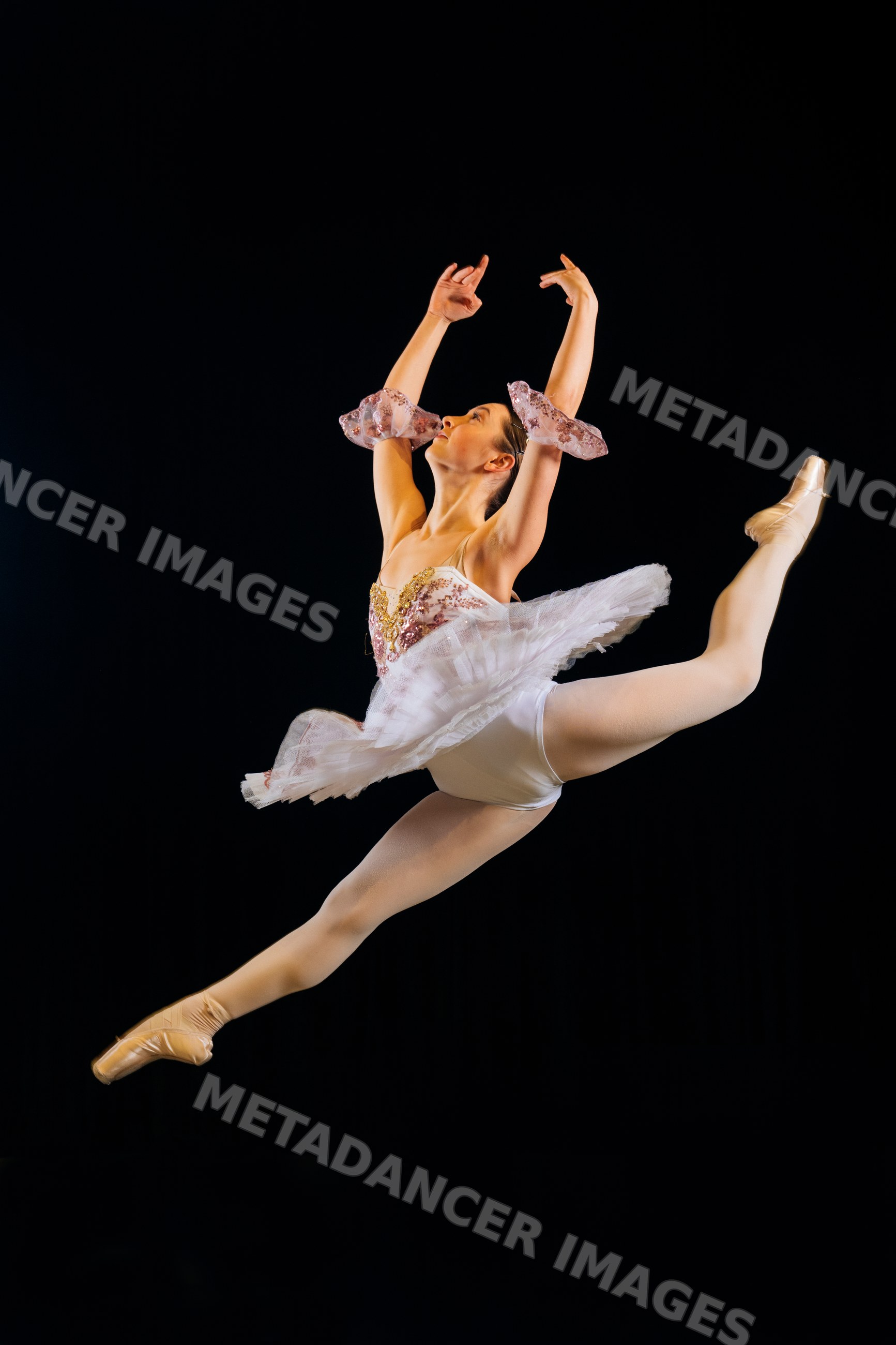 Female ballet dancer performs a graceful leap