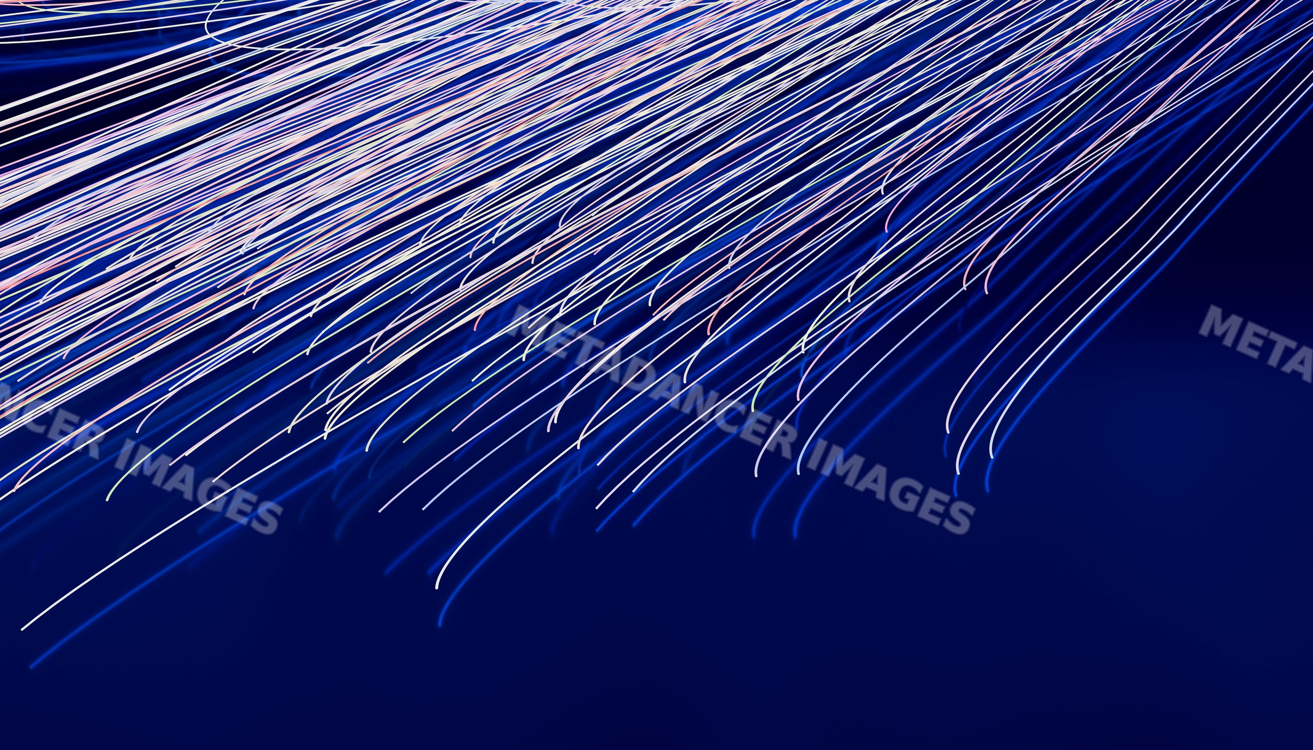Fiber optic cables with blue light streaks illustrating digital data