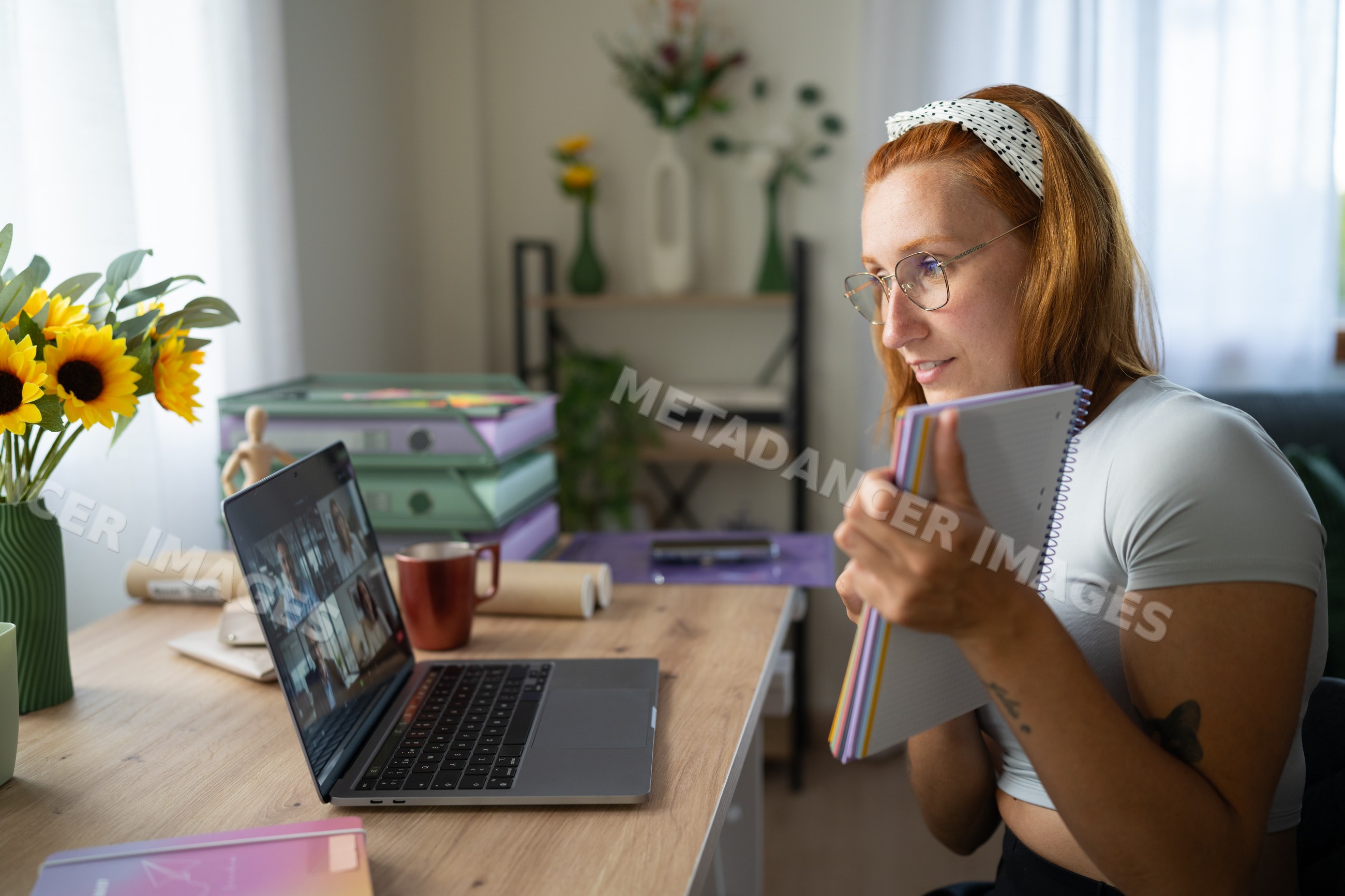 A white woman working from home participates