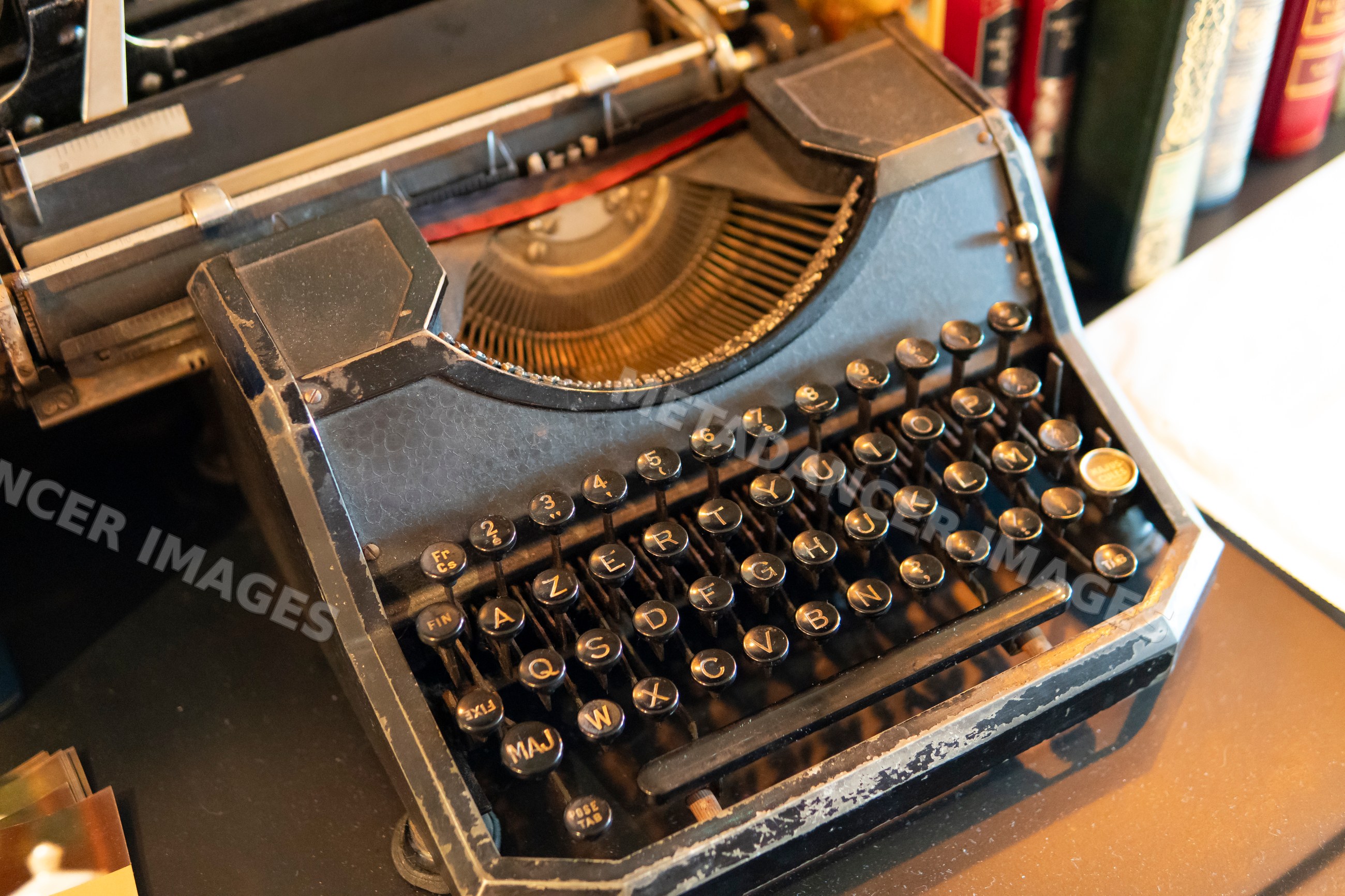 Old black typewriter with vintage keyboard on desk in Verdun, France