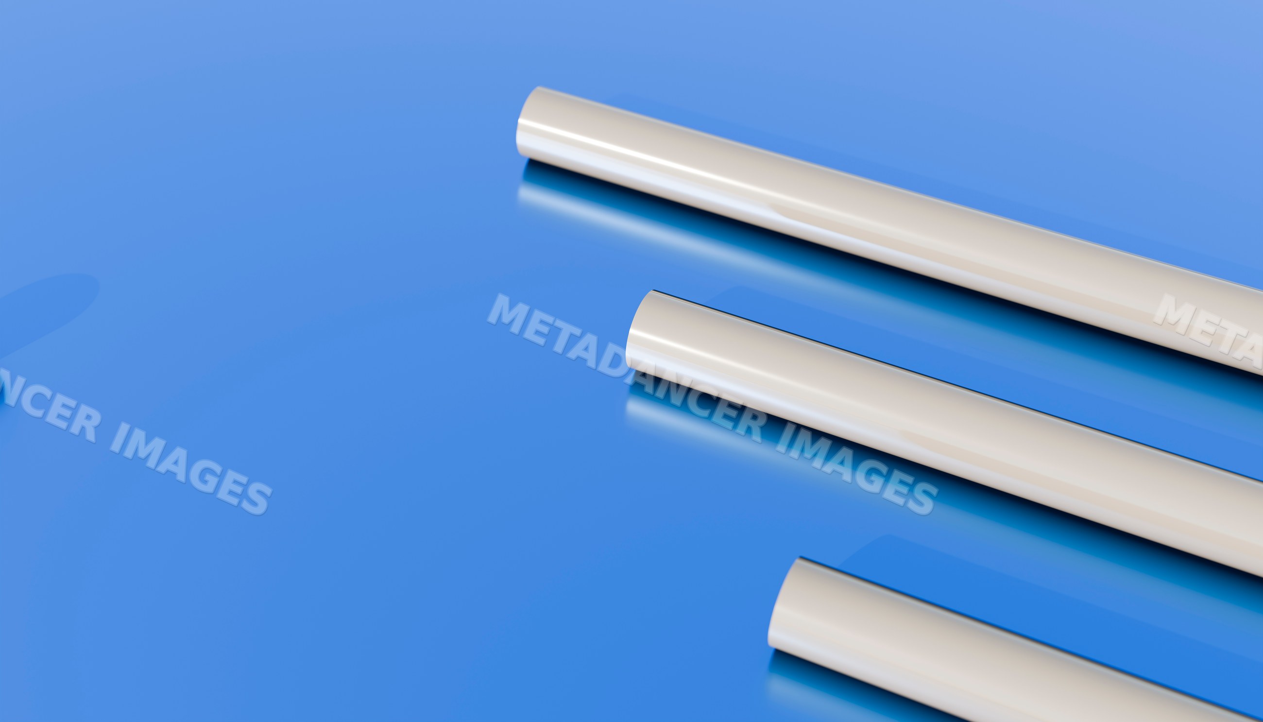 Three white cylindrical plastic tubes on glossy blue surface