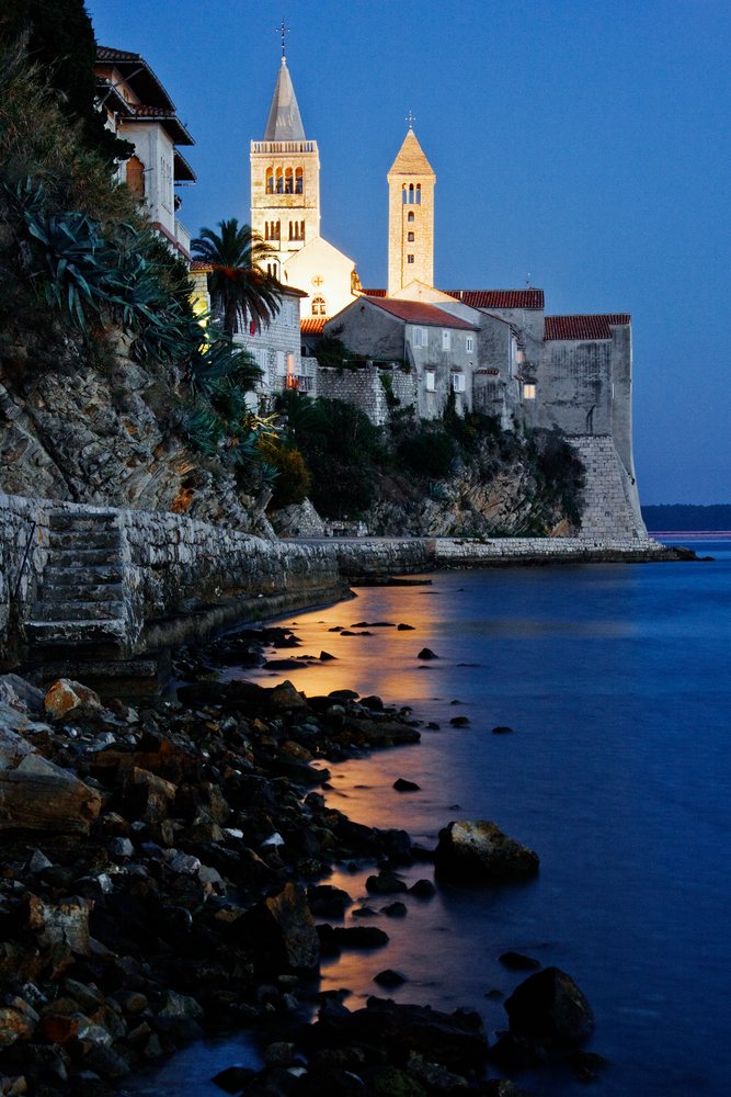 Seaside town with historic church towers on rab island, croatia