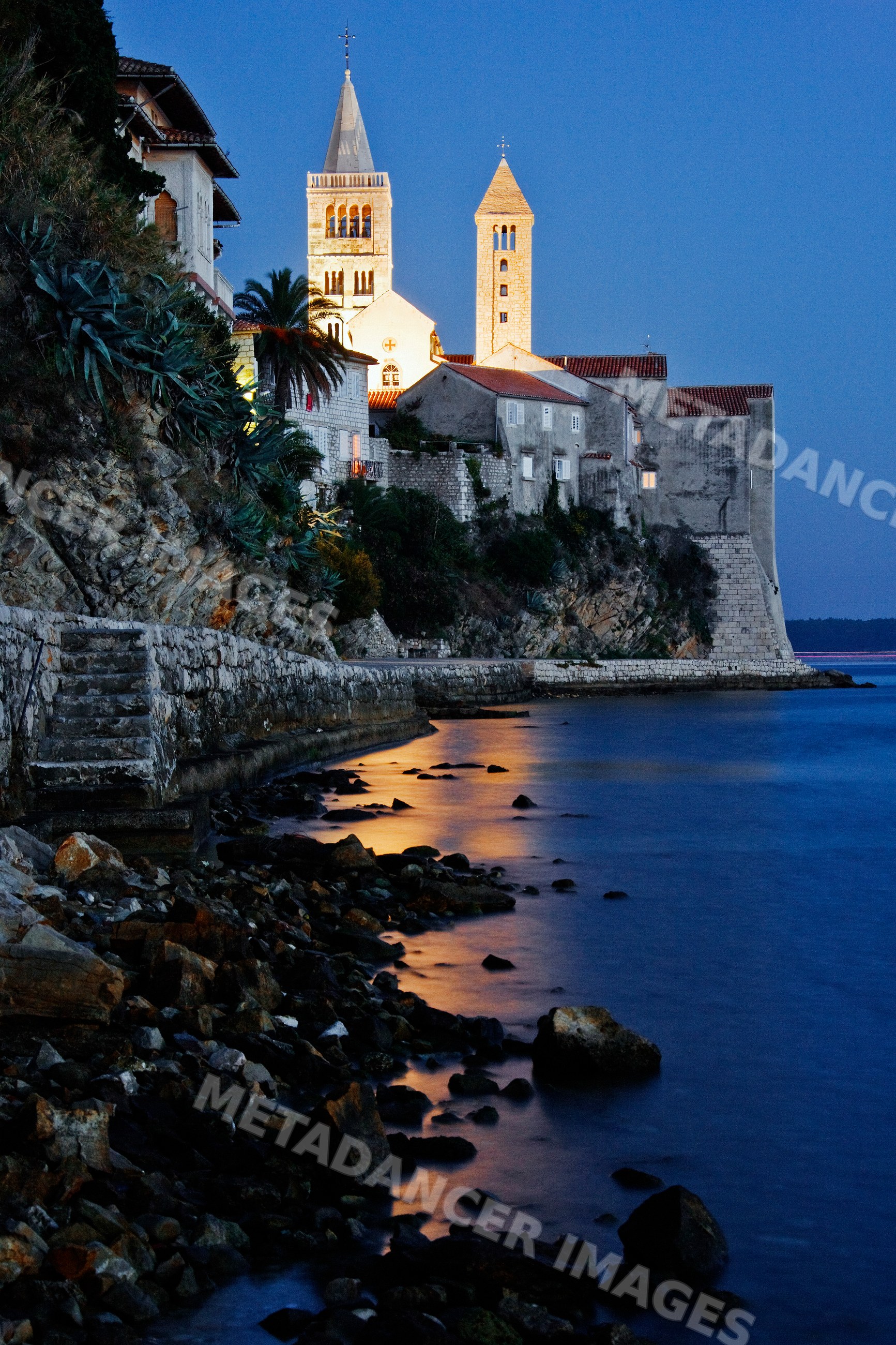 Seaside town with historic church towers on rab island, croatia