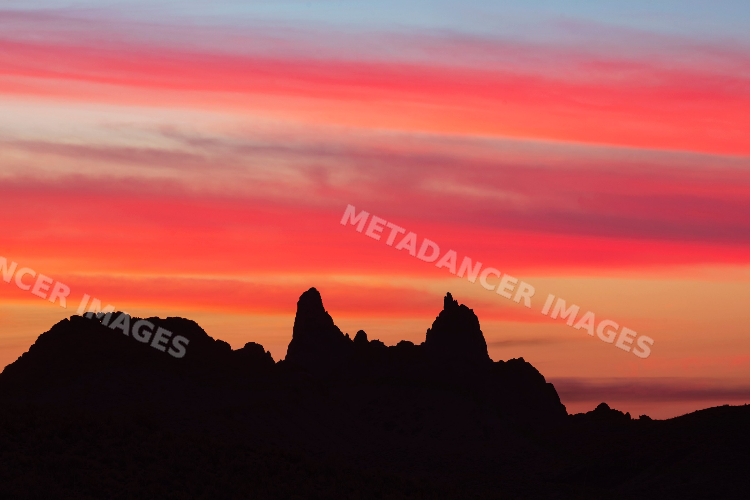 Silhouette of Mule Ears rock formations at Sunrise in a park