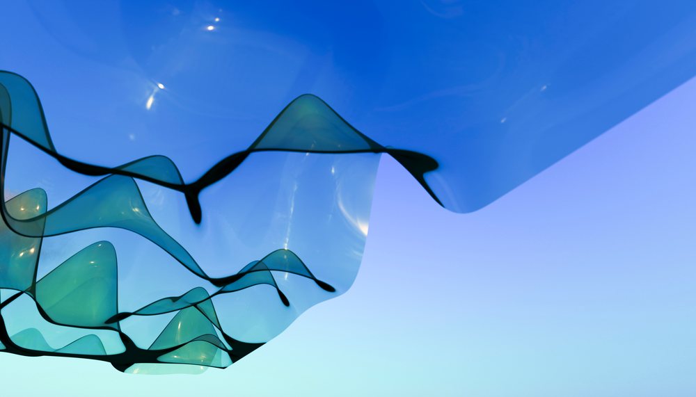 Abstract flowing translucent blue ribbons against blue background