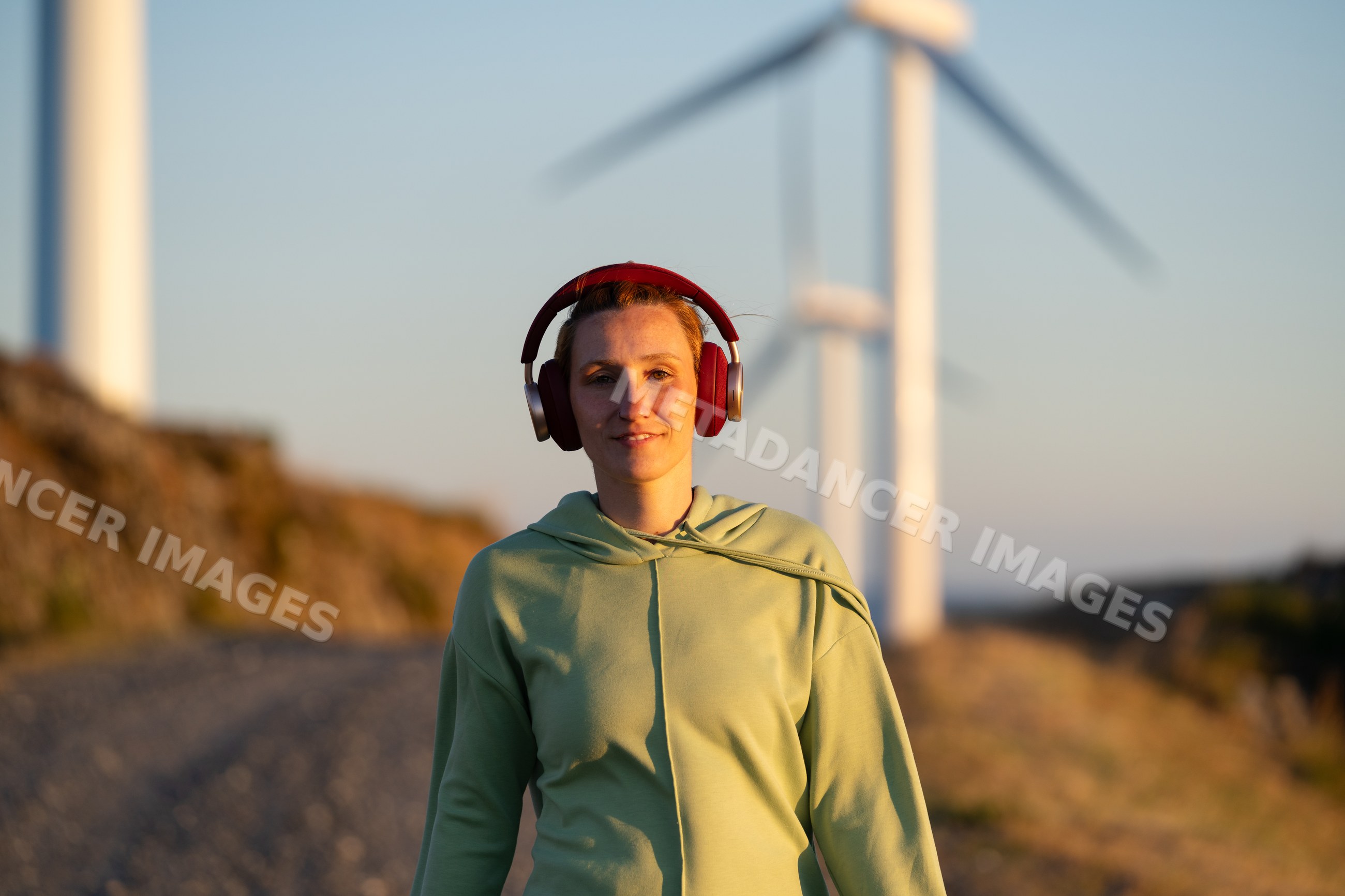 White Woman walking near wind turbines