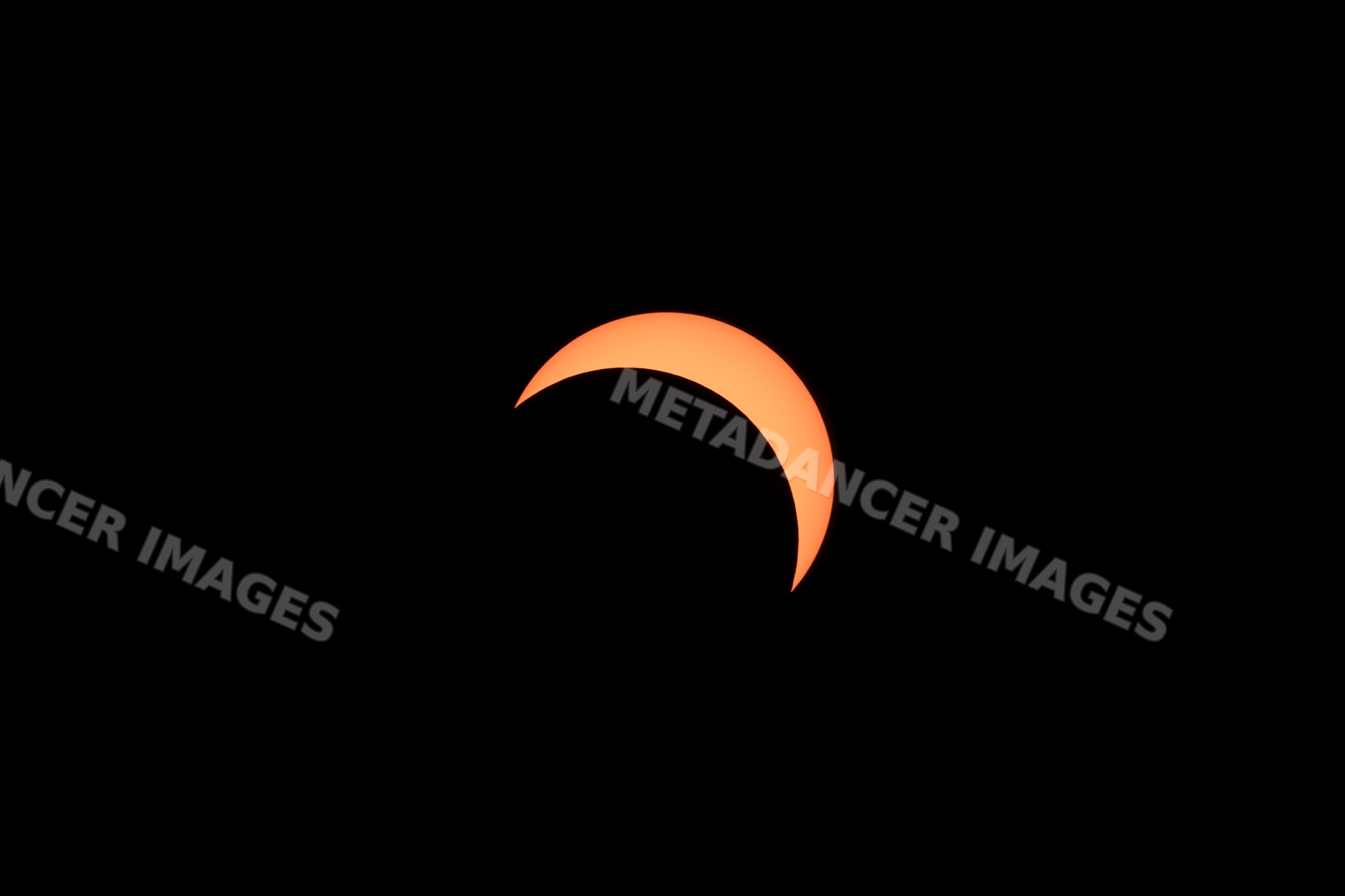 Solar eclipse showing crescent sun silhouette in dark sky