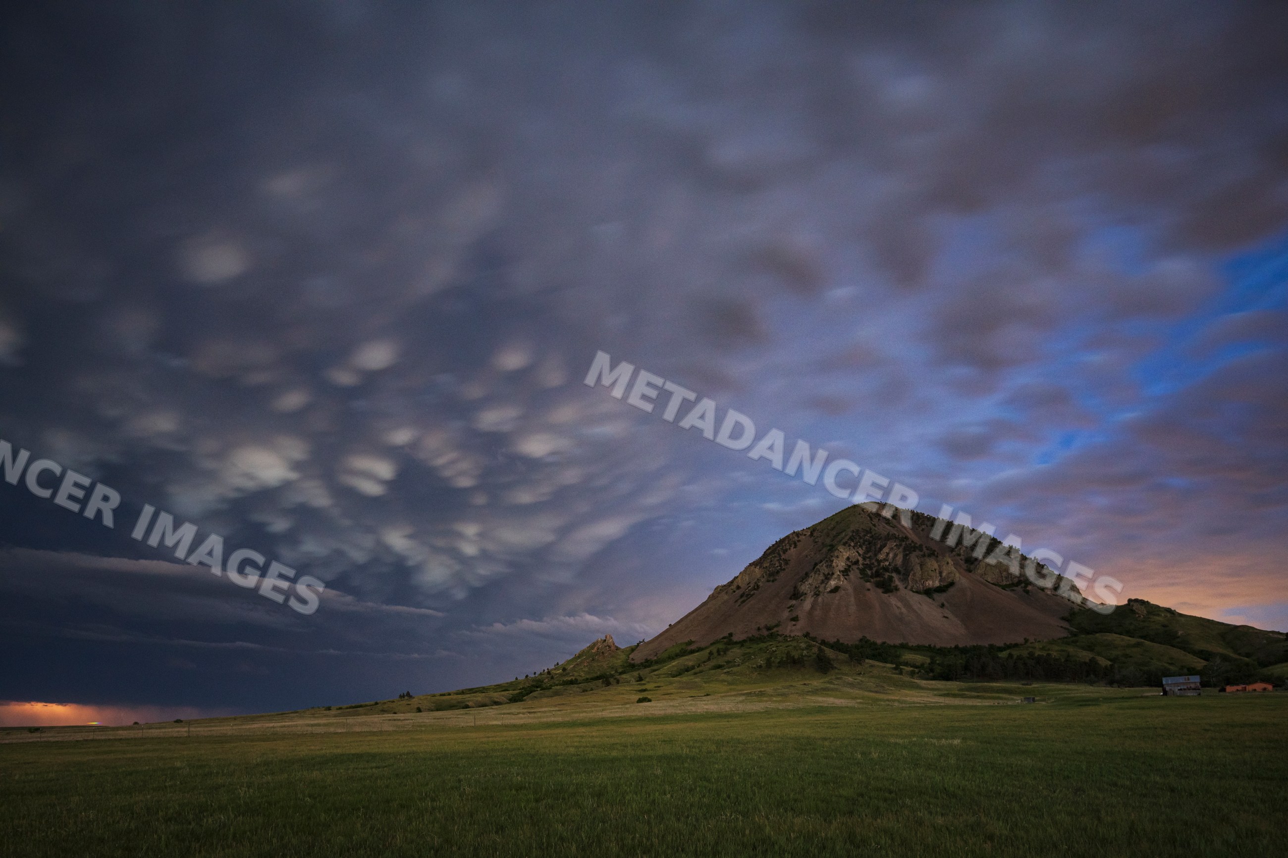 Receding Storm over bear Butte mountain in south dakota grassland