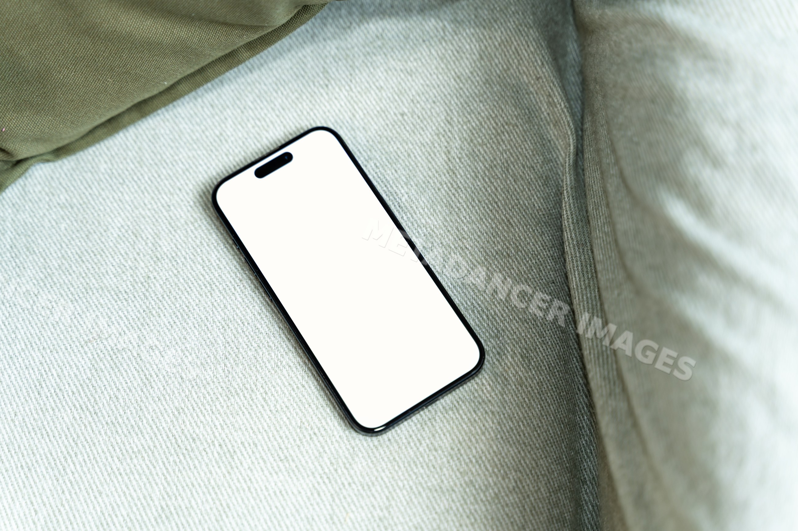Smartphone with blank screen on fabric surface