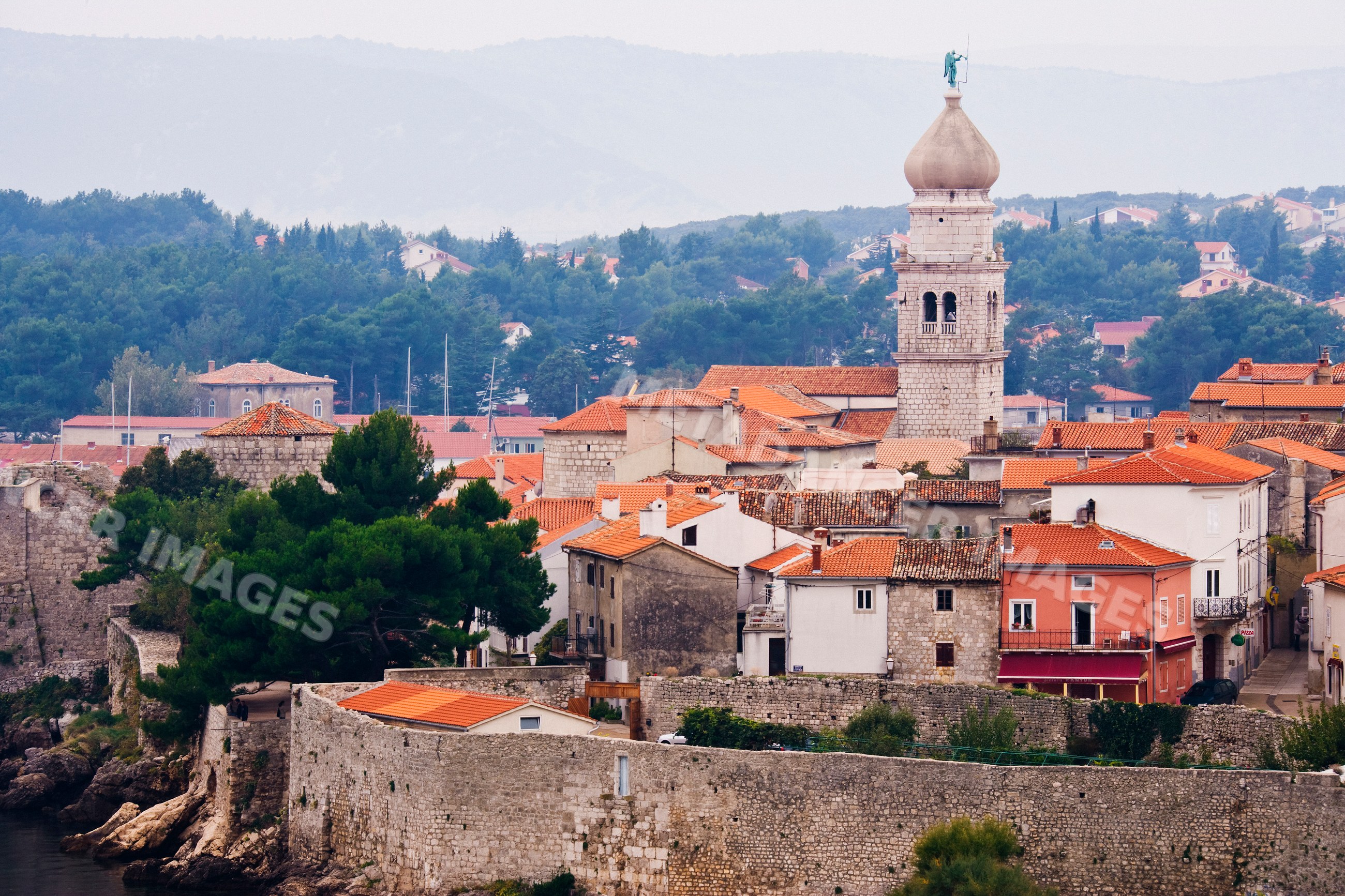 Old town of krk island with church tower and stone walls