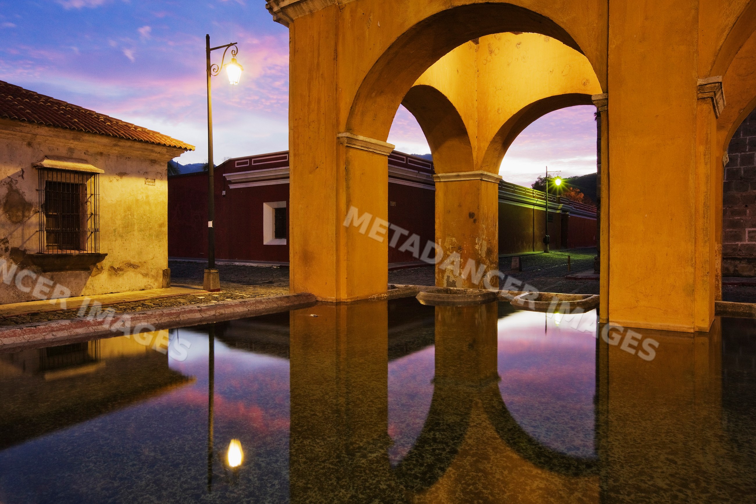 Tanque de la union reflecting colonial arches at twilight guatemala