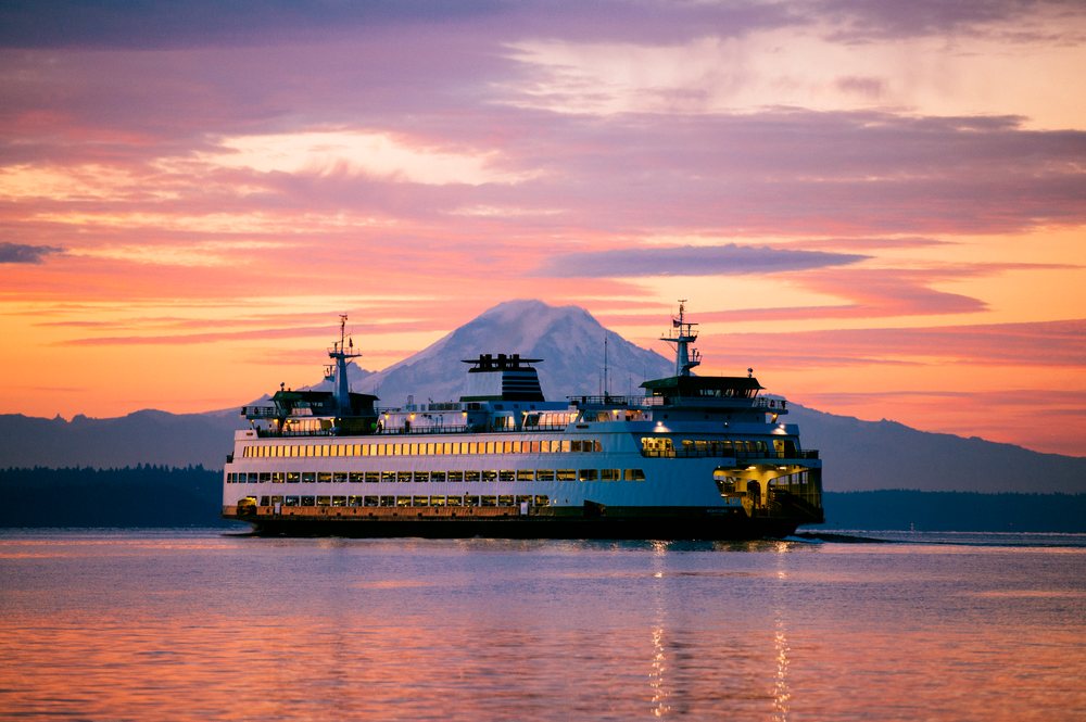 Ferry sailing near Bainbridge Island with mount rainier at sunset