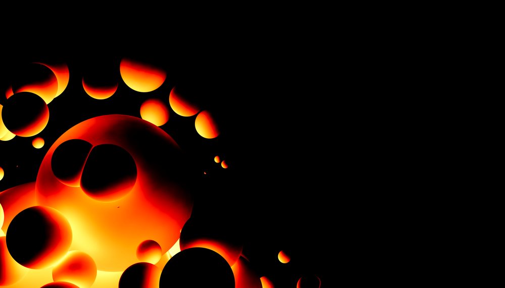 Glowing orange spheres float on a black background