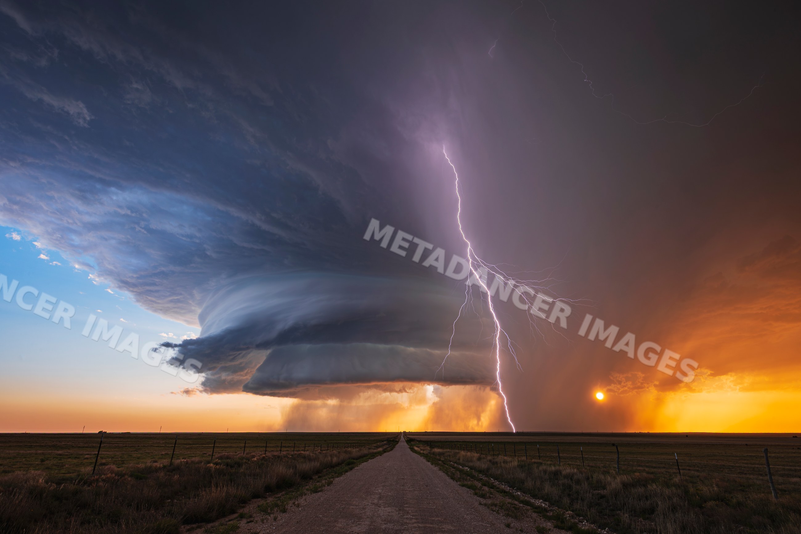 Supercell storm with Lightning over road at sunset in new mexico