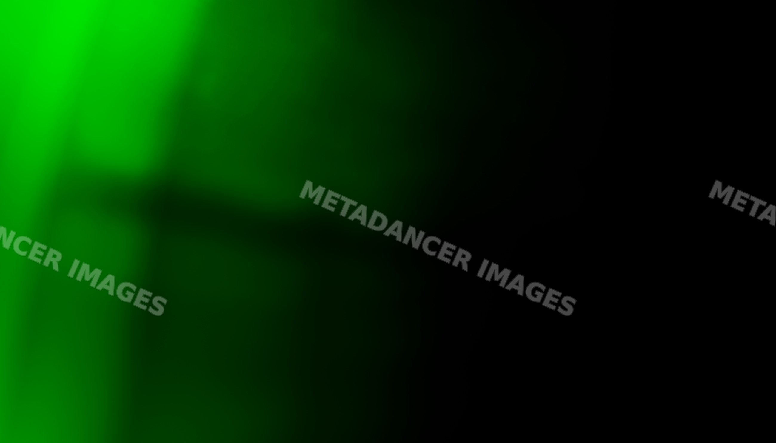 Abstract green glowing light with shadow effects on dark background