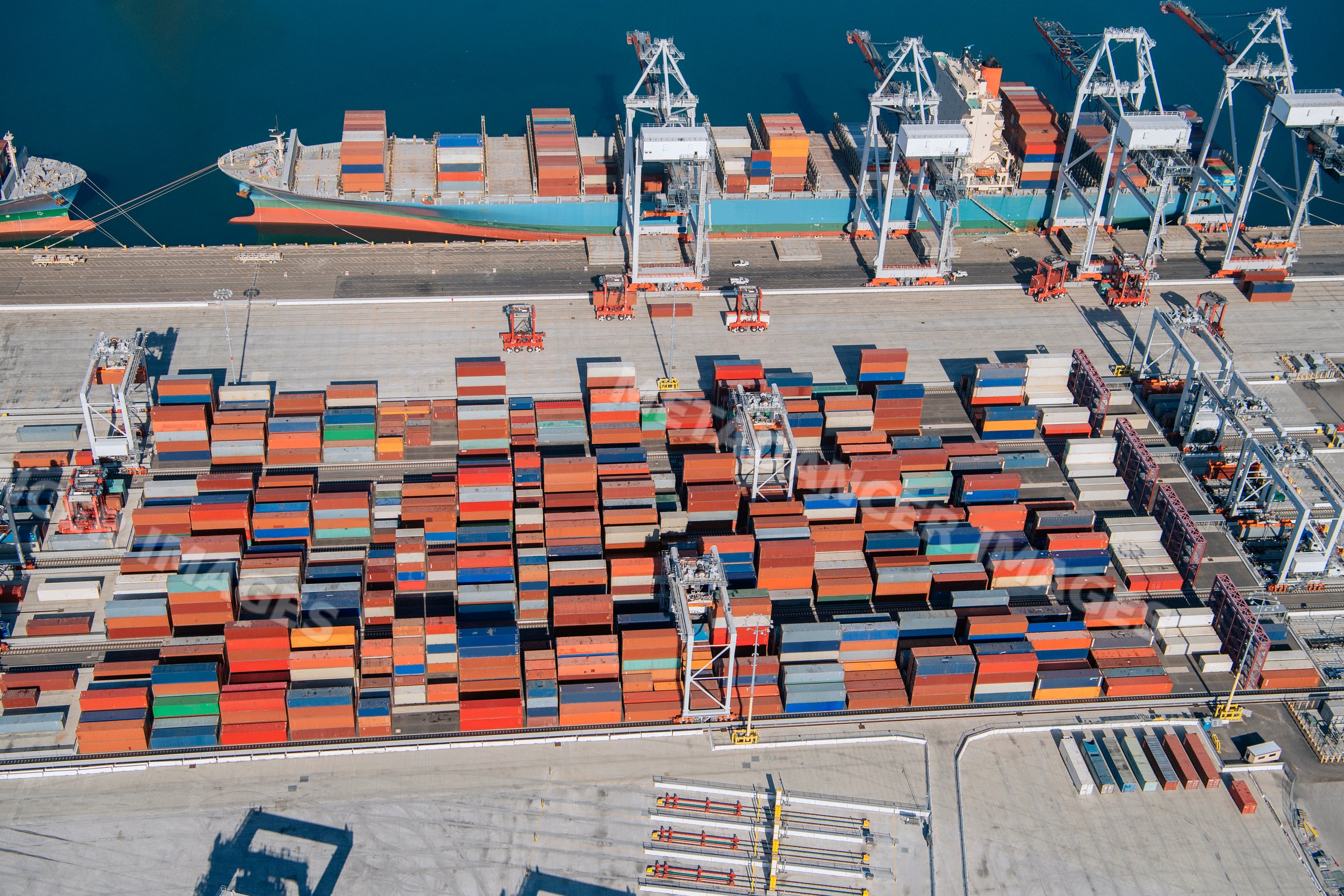 Shipping containers and cargo ship at a container terminal in a beach
